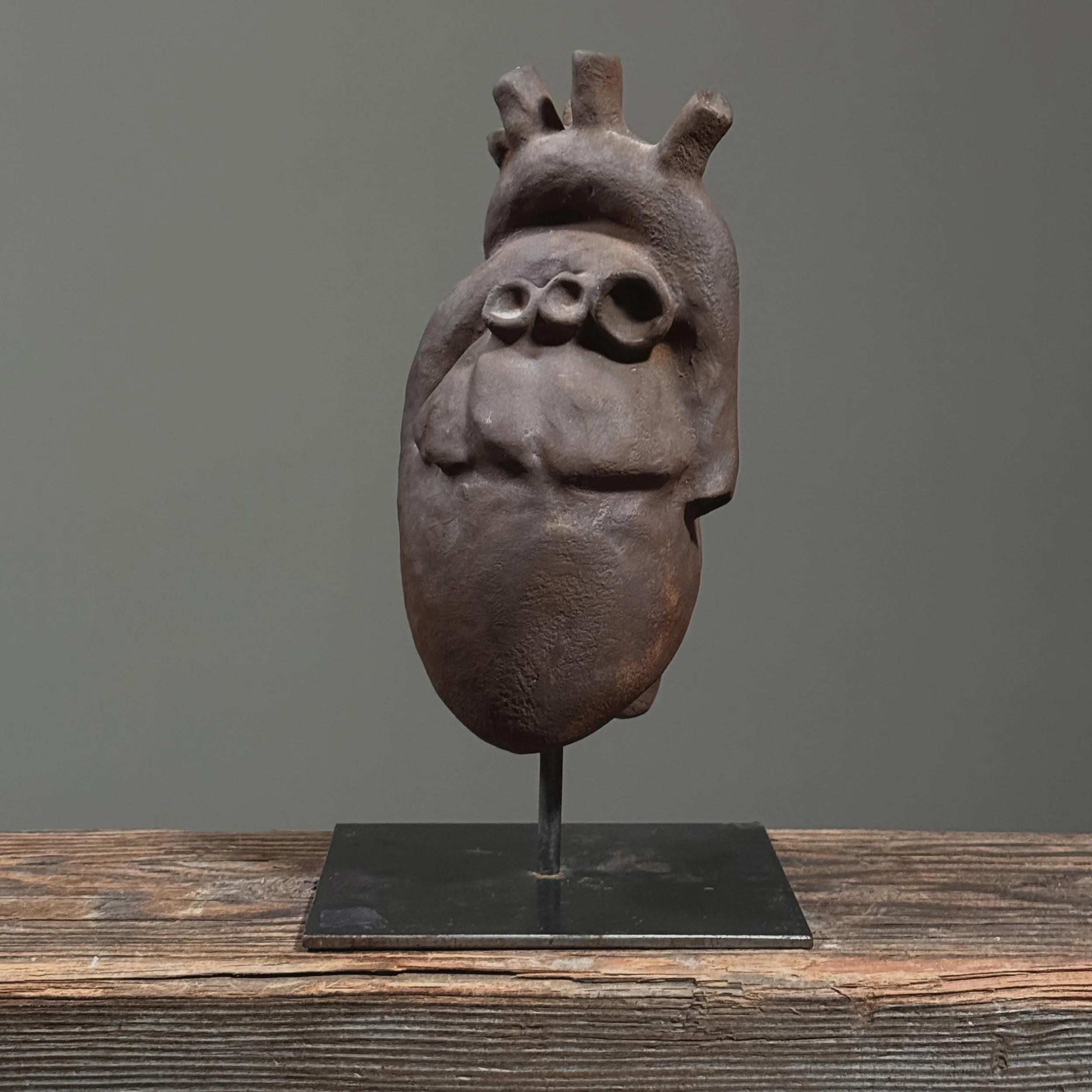 Side view of hand-built clay heart artwork