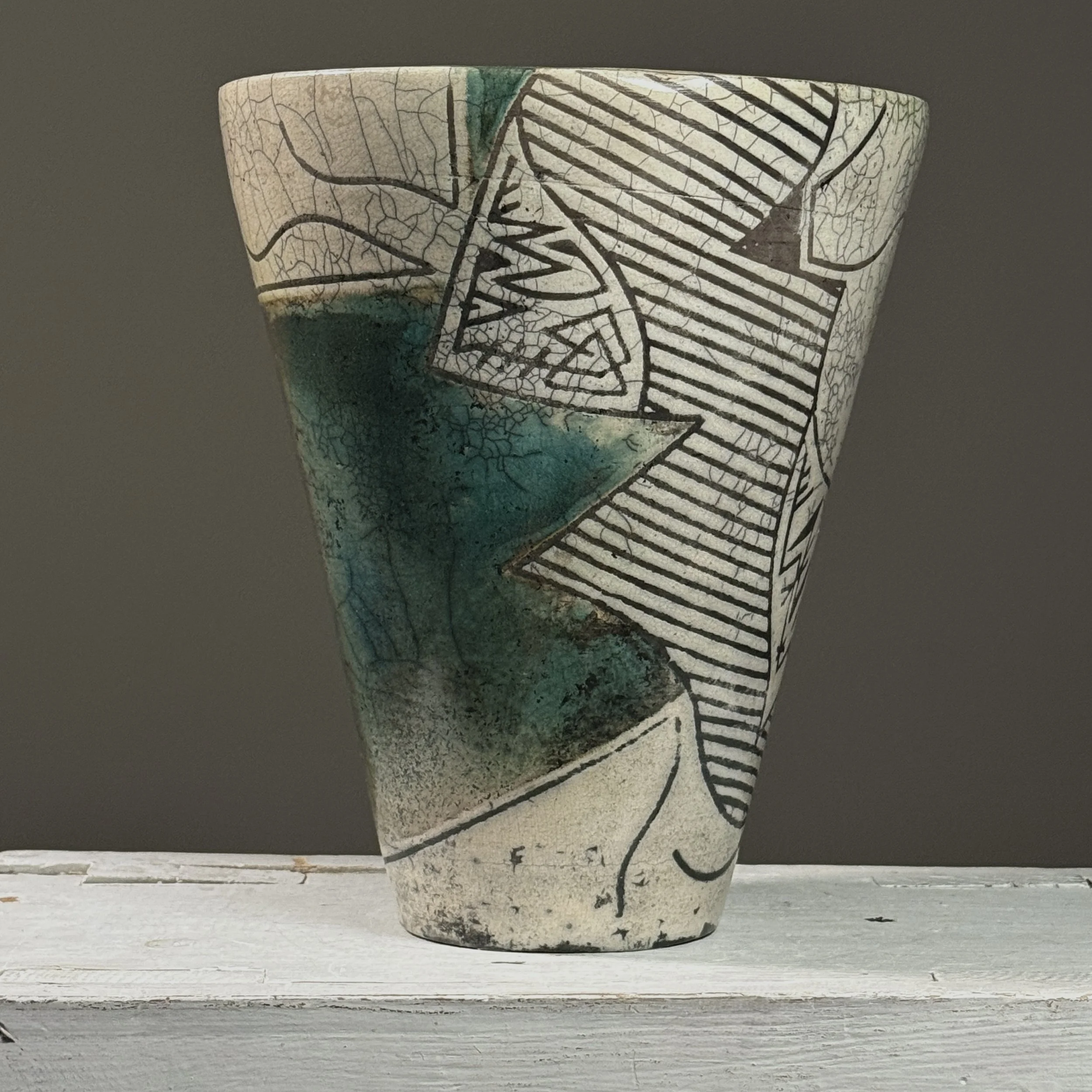 Full view of vintage 1984 postmodernist raku crackle glaze ceramic vessel, signed on side, blue-green glaze areas and black line detail