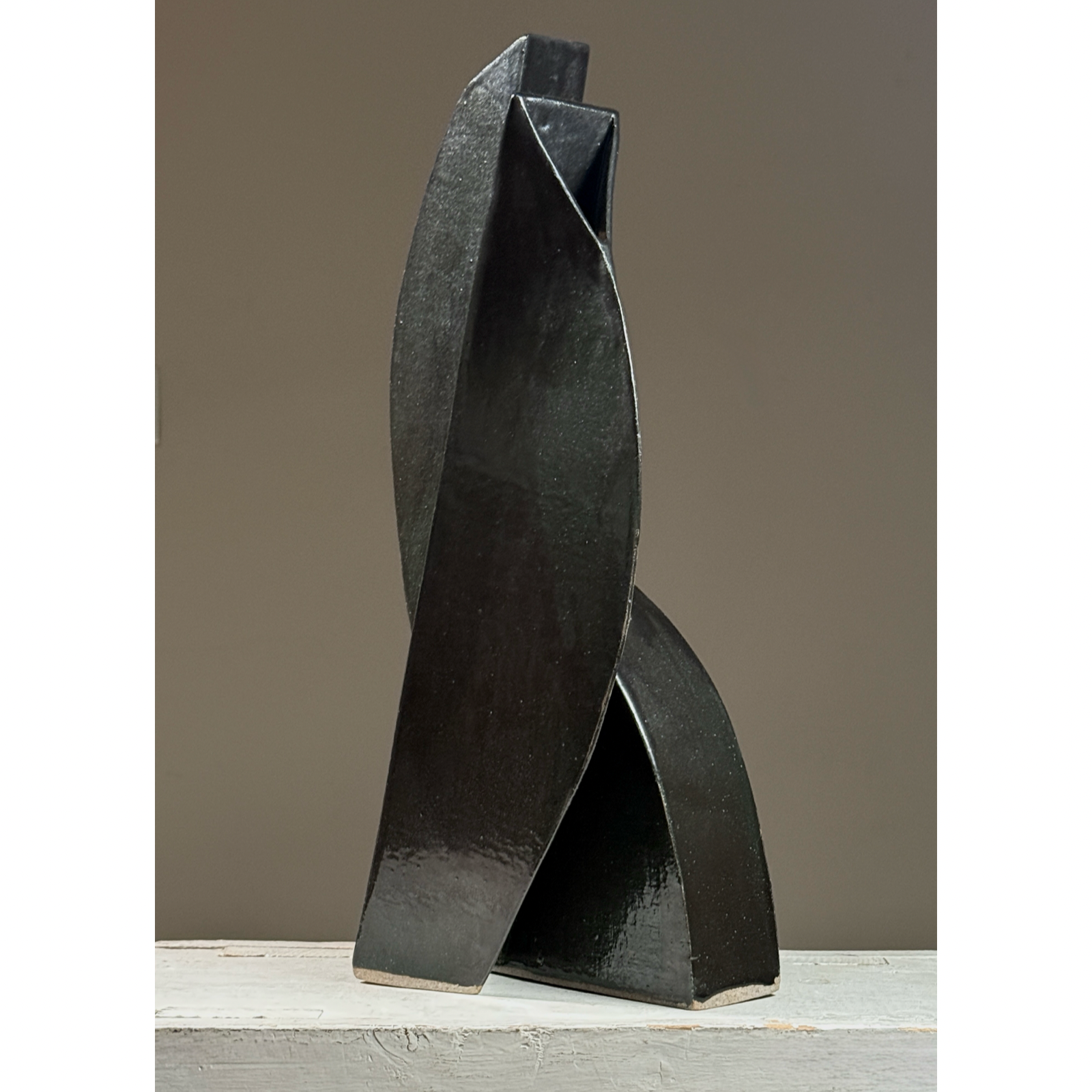 Postmodernist sculptural ceramic ikebana vessel. Glossy black and subtle green glaze. 18.25 inches height.