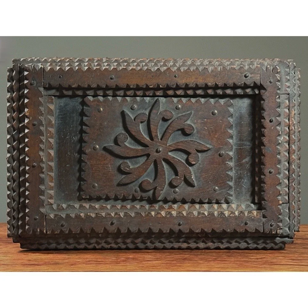 Overall shot of the antique tramp art chest, showcasing its bold, folk art aesthetic.