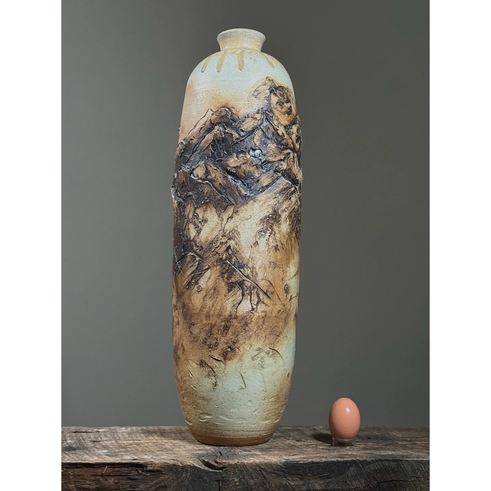 Overall view of tall Brutalist ceramic vessel with egg for size reference