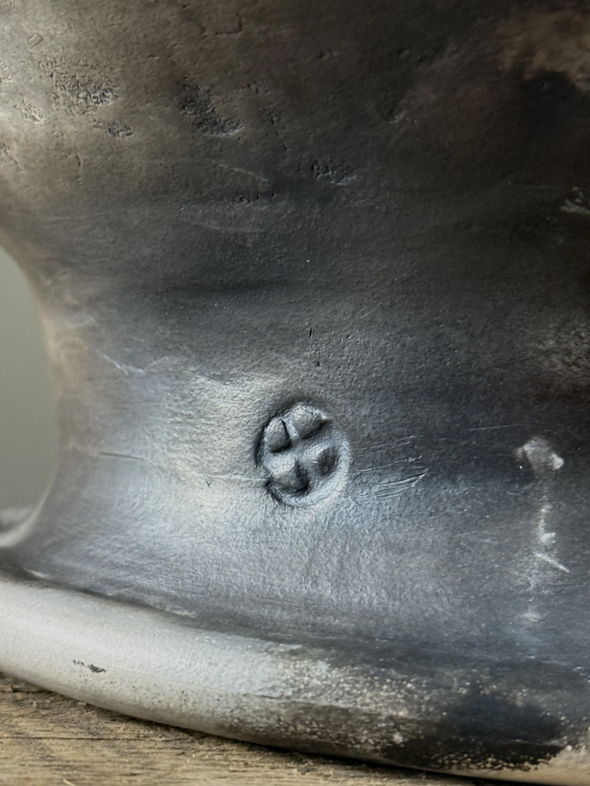 Vintage raku fired vessel with hole in center, signed with maker's mark