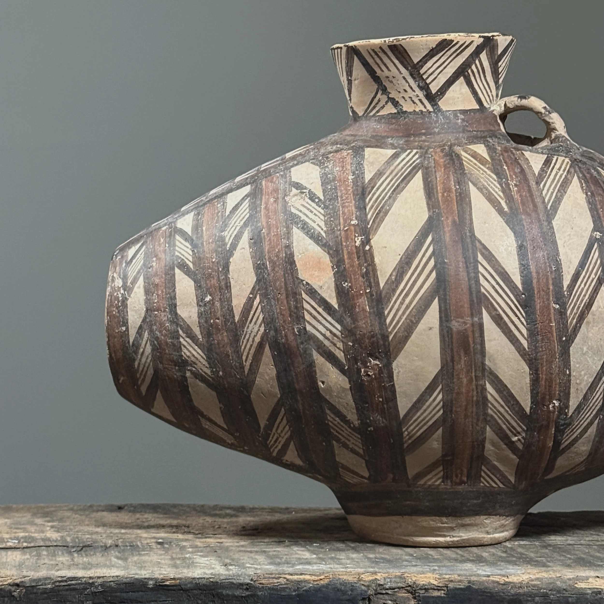 Hand-painted terracotta vessel with curved profile