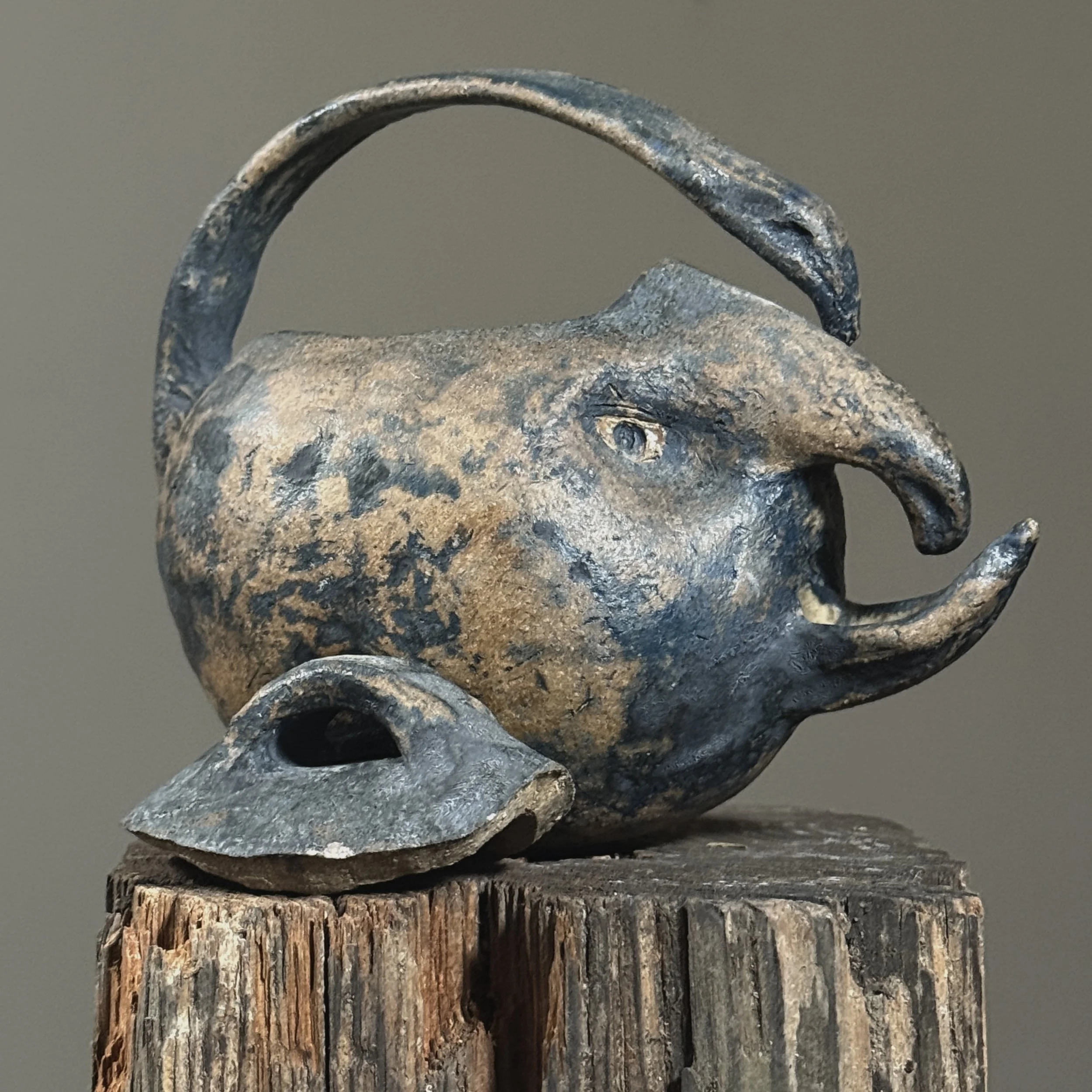Wood-fired handmade teapot with sculptural facial features with lid.