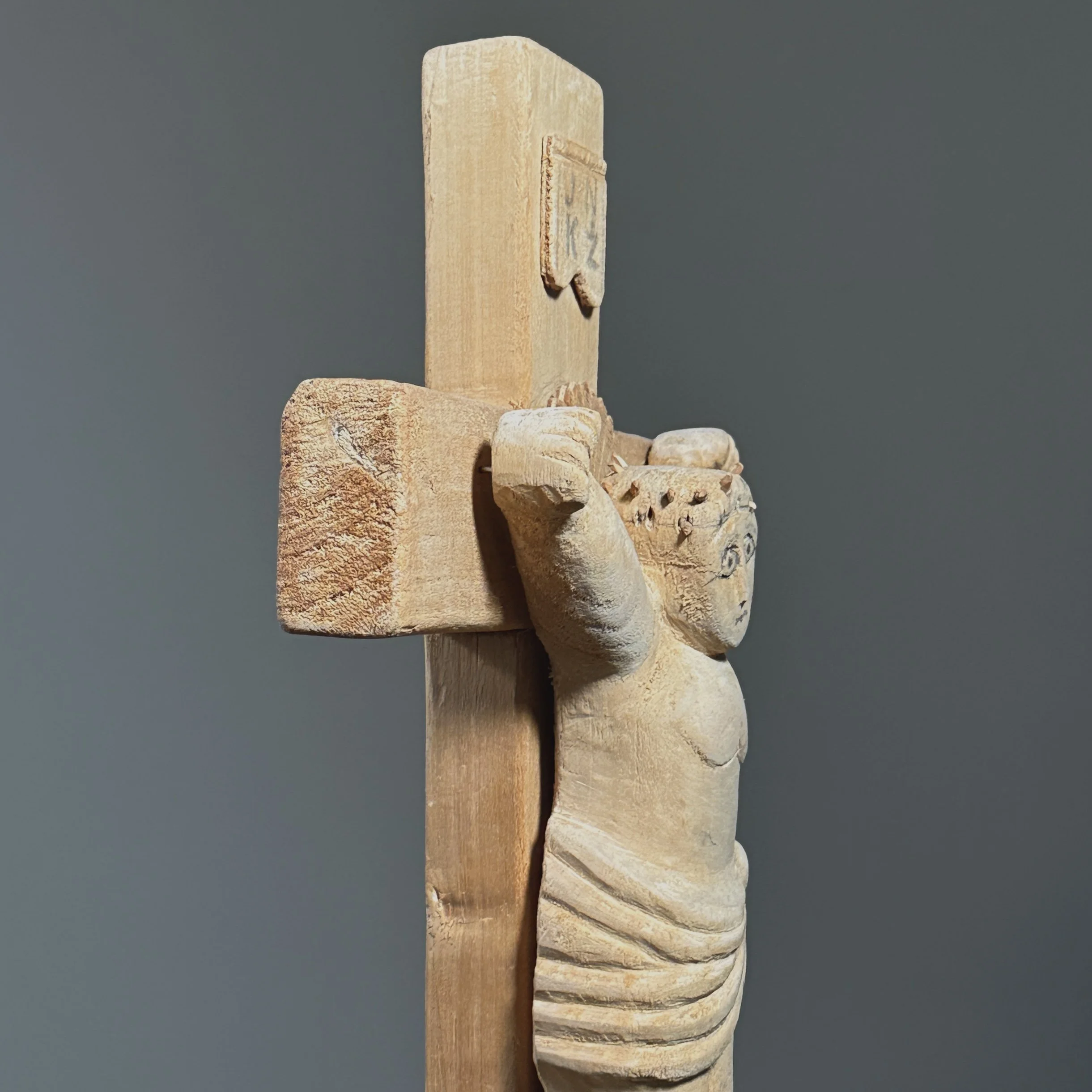 Side angle of hand-carved wood crucifix sculpture