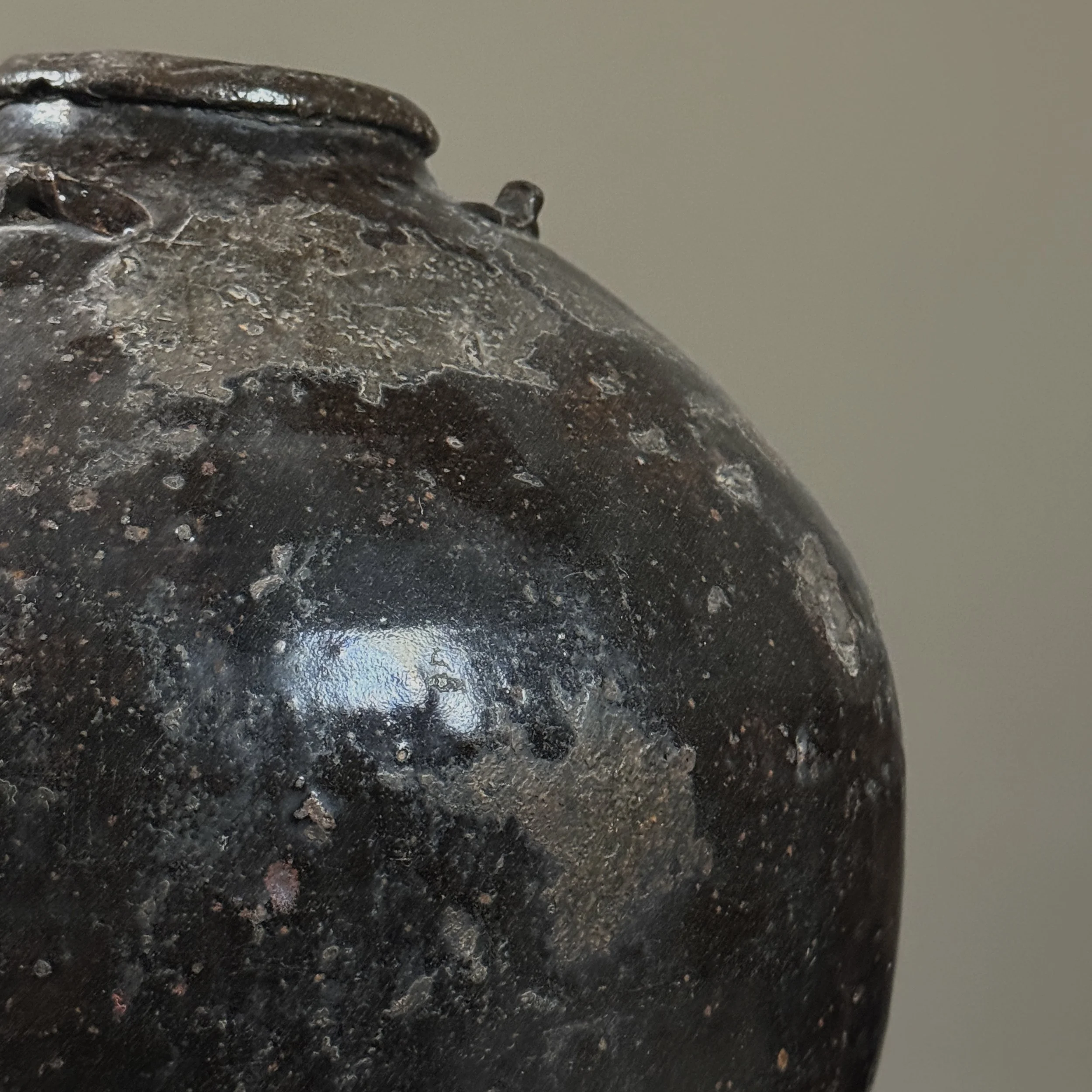 Close-up of lug handle on antique Chinese ceramic vessel