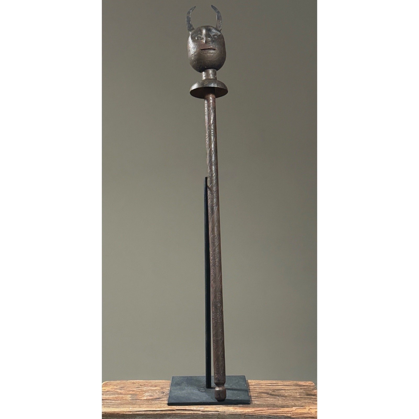 Full front view of antique hand-forged metal devil mace standing 27.5 inches tall on neutral background