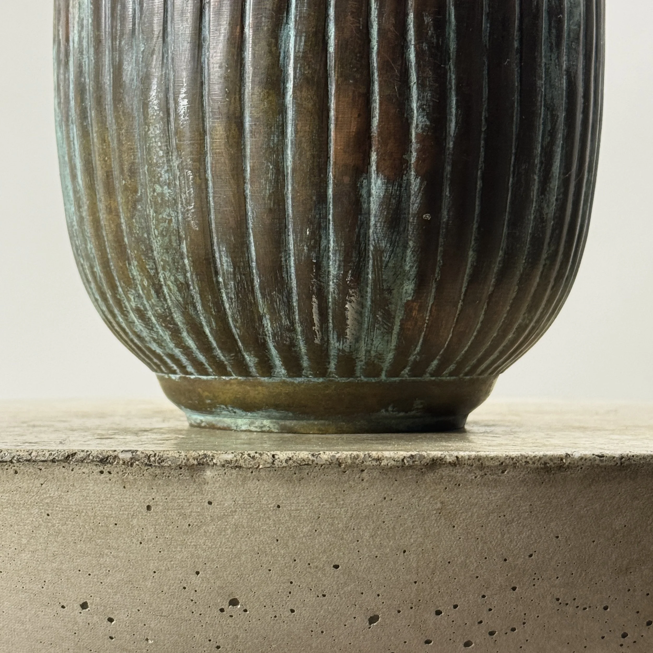 Detail view of verdegris patination on greyish-brown brass vase, Art Deco style, antique