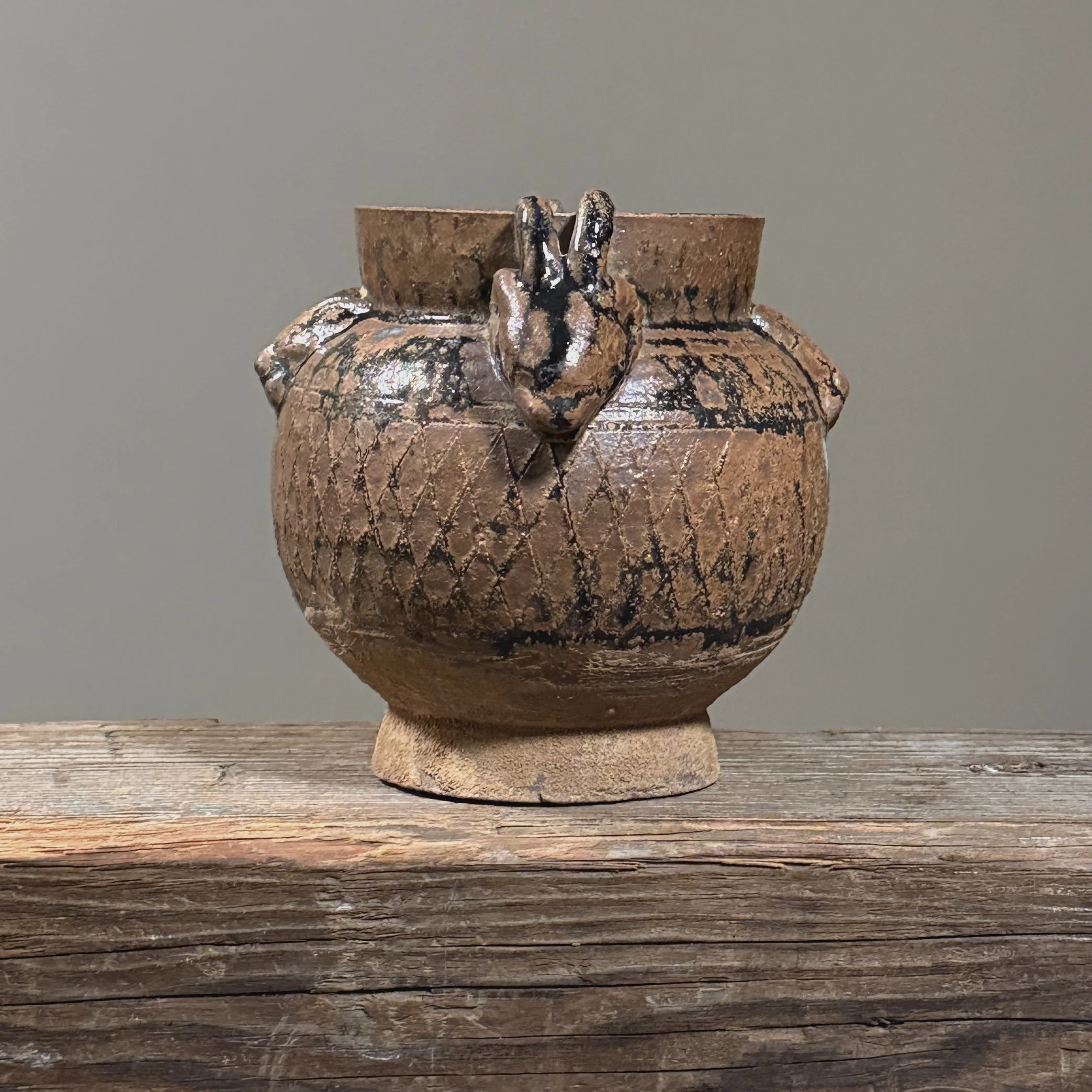 Full frontal view of the Han Dynasty-style globular jar with ram-head handles.