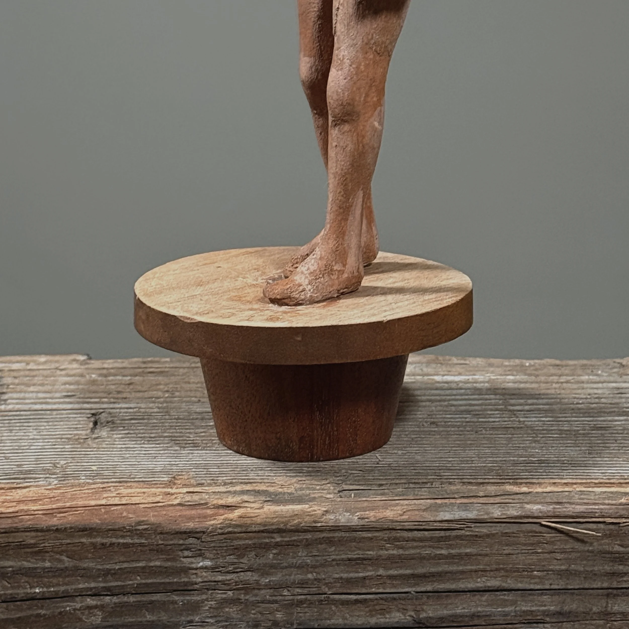 Vintage folk art sculpture with tapered wooden stand