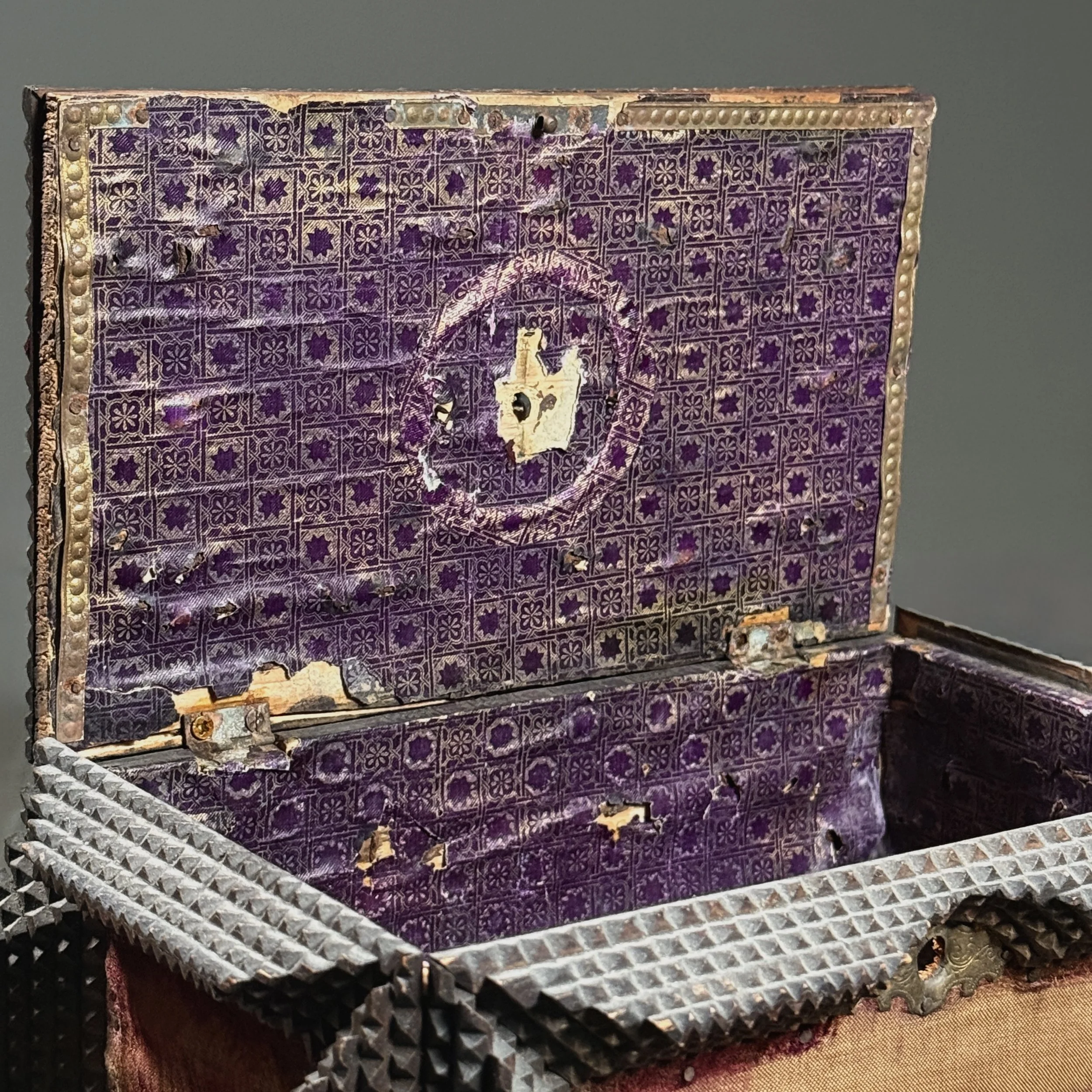 Interior view showing purple star-patterned paper lining.