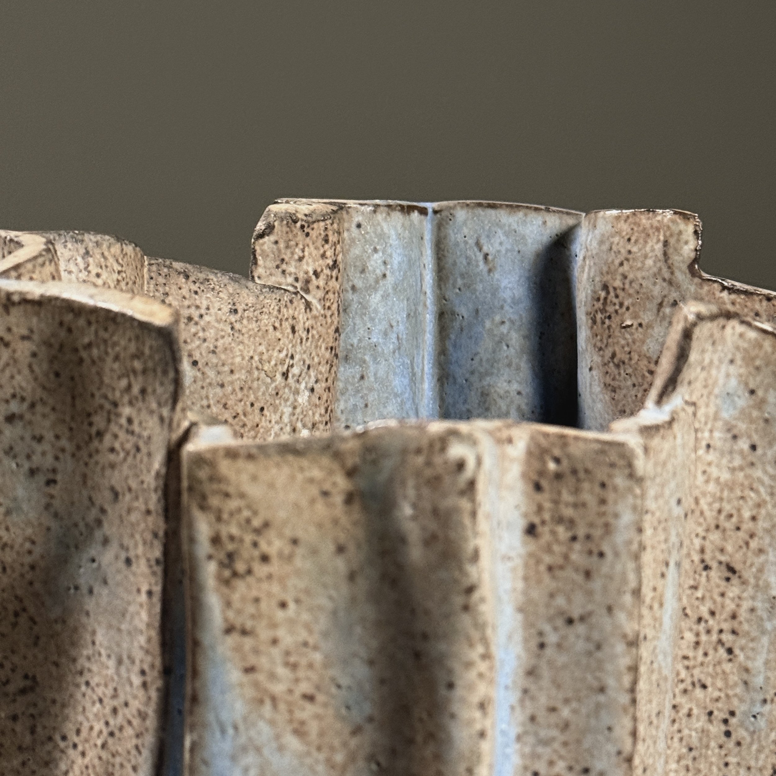 Detail of grey speckled glaze surface with blue accents.
