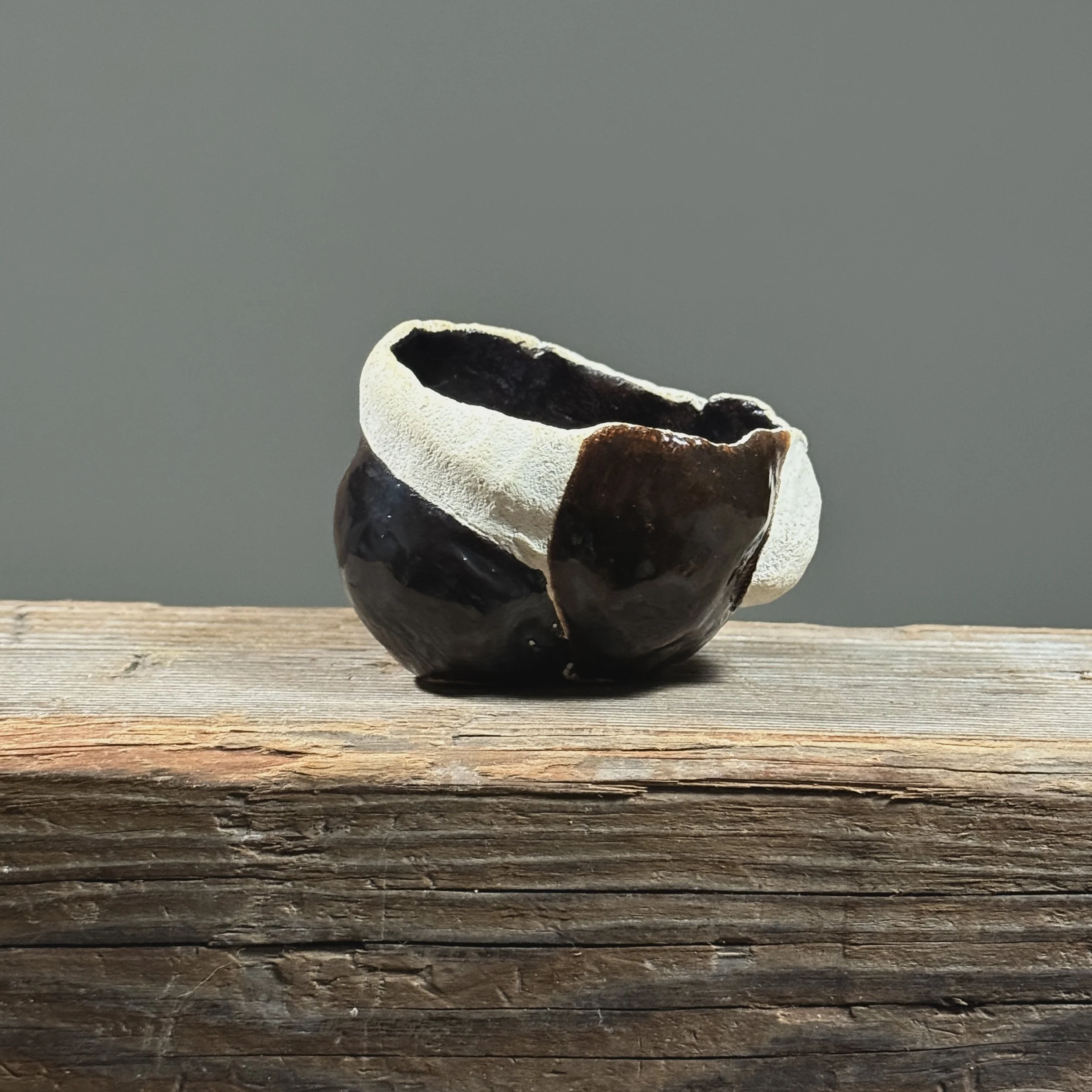 Glossy black vessel. Smooth finish. Modernist silhouette.