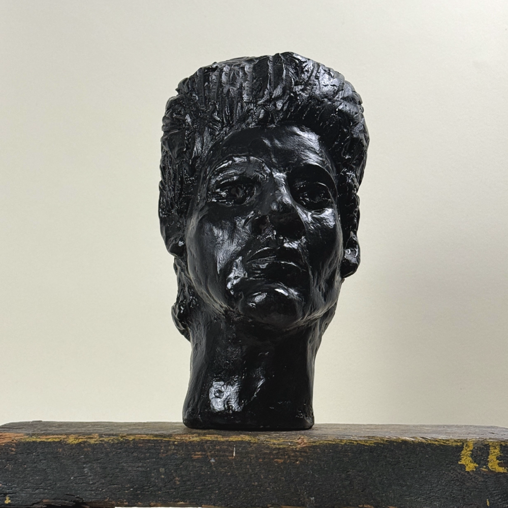 Front view of portrait sculpture. Expressionist features. Painted plaster.