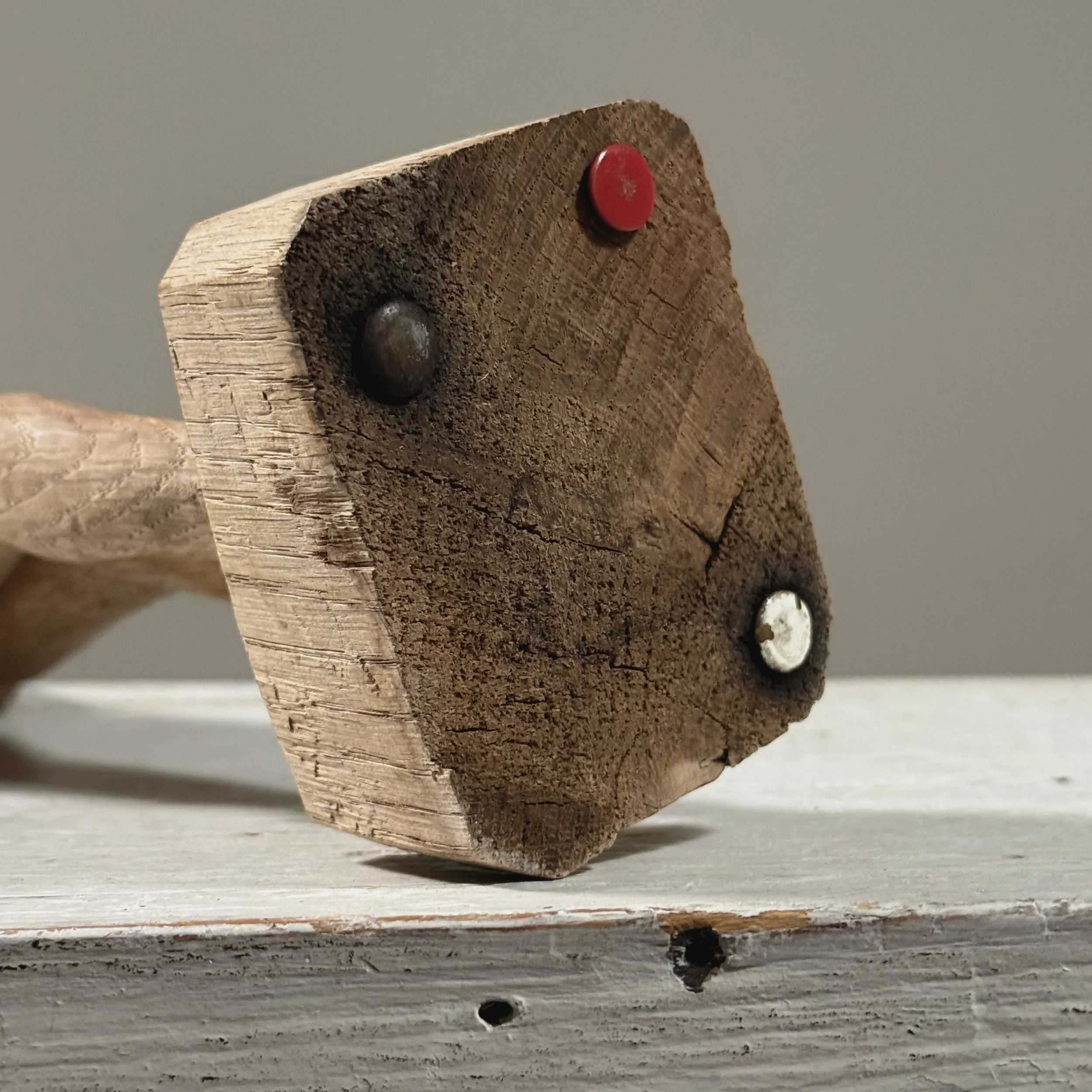 Detail view of integral base on vintage hand carved wood female nude sculpture, modernist style