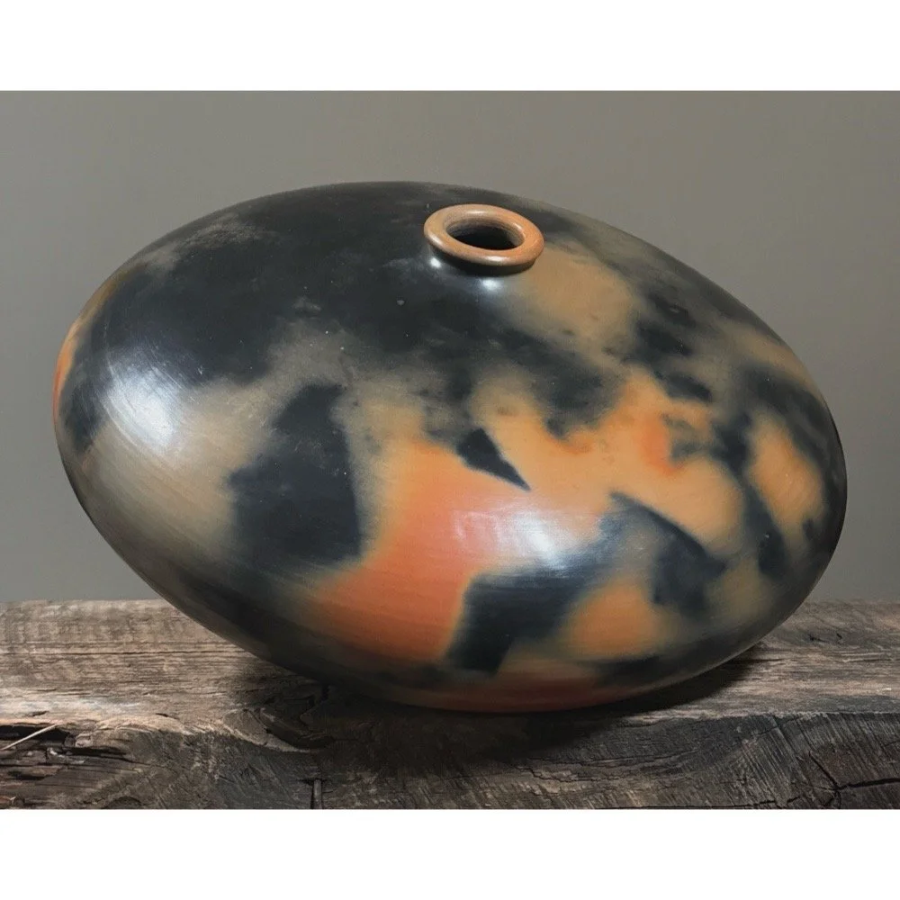 Monumental vintage organic modern seed pot with orange and black smoke-fired finish.