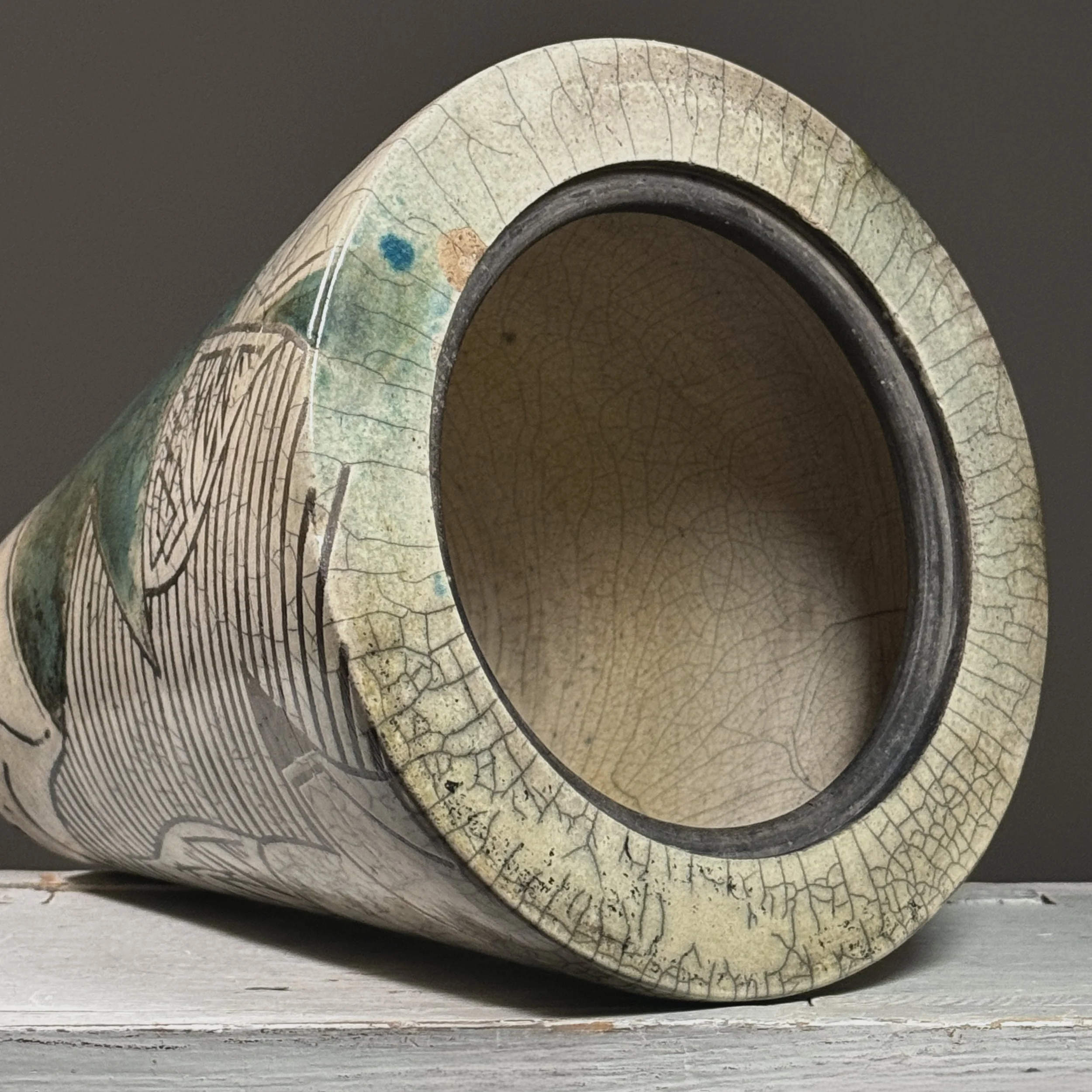 Detail of rim and opening of 1984 signed raku crackle glaze vessel, showing glaze application