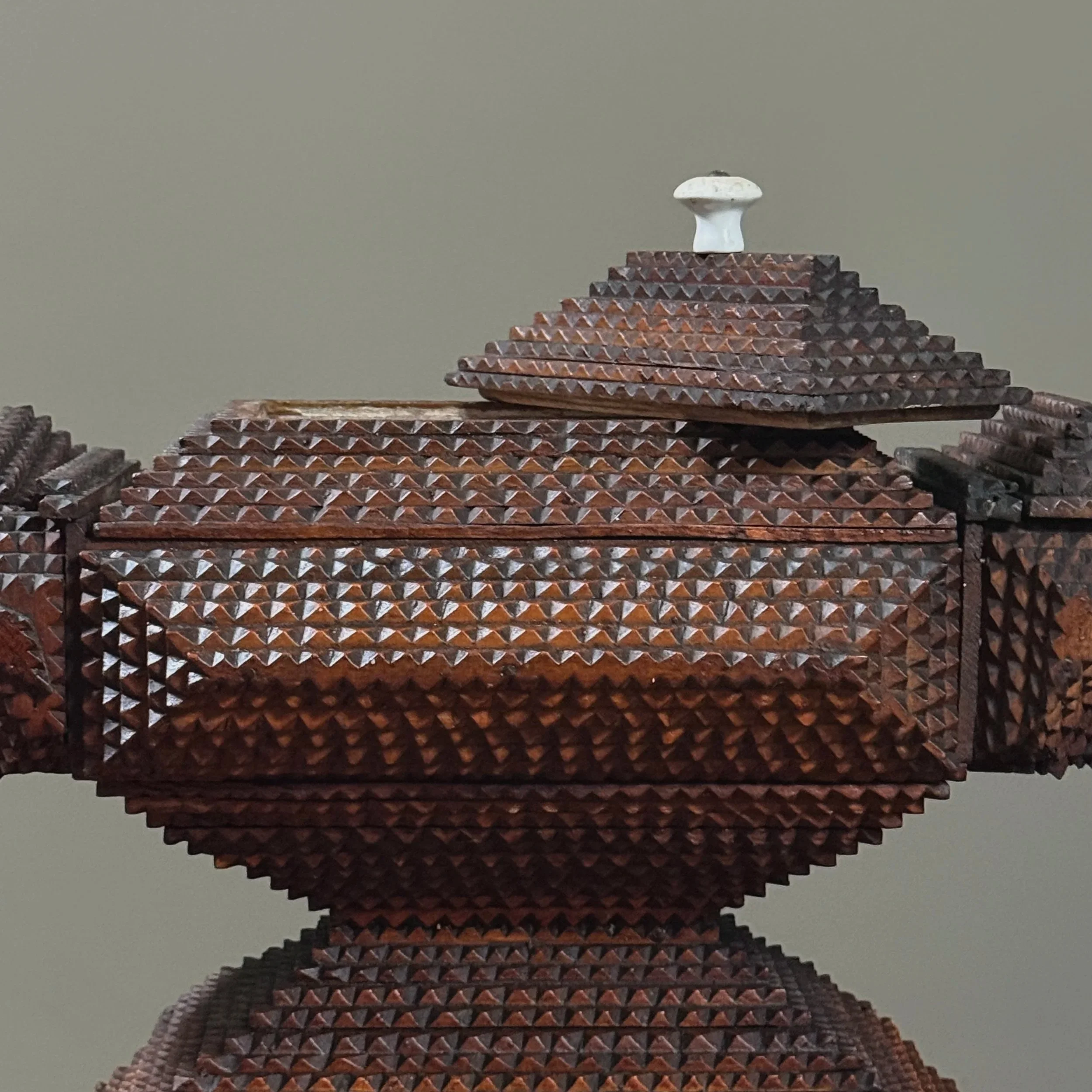 Close-up of removable finial lid revealing secret compartment