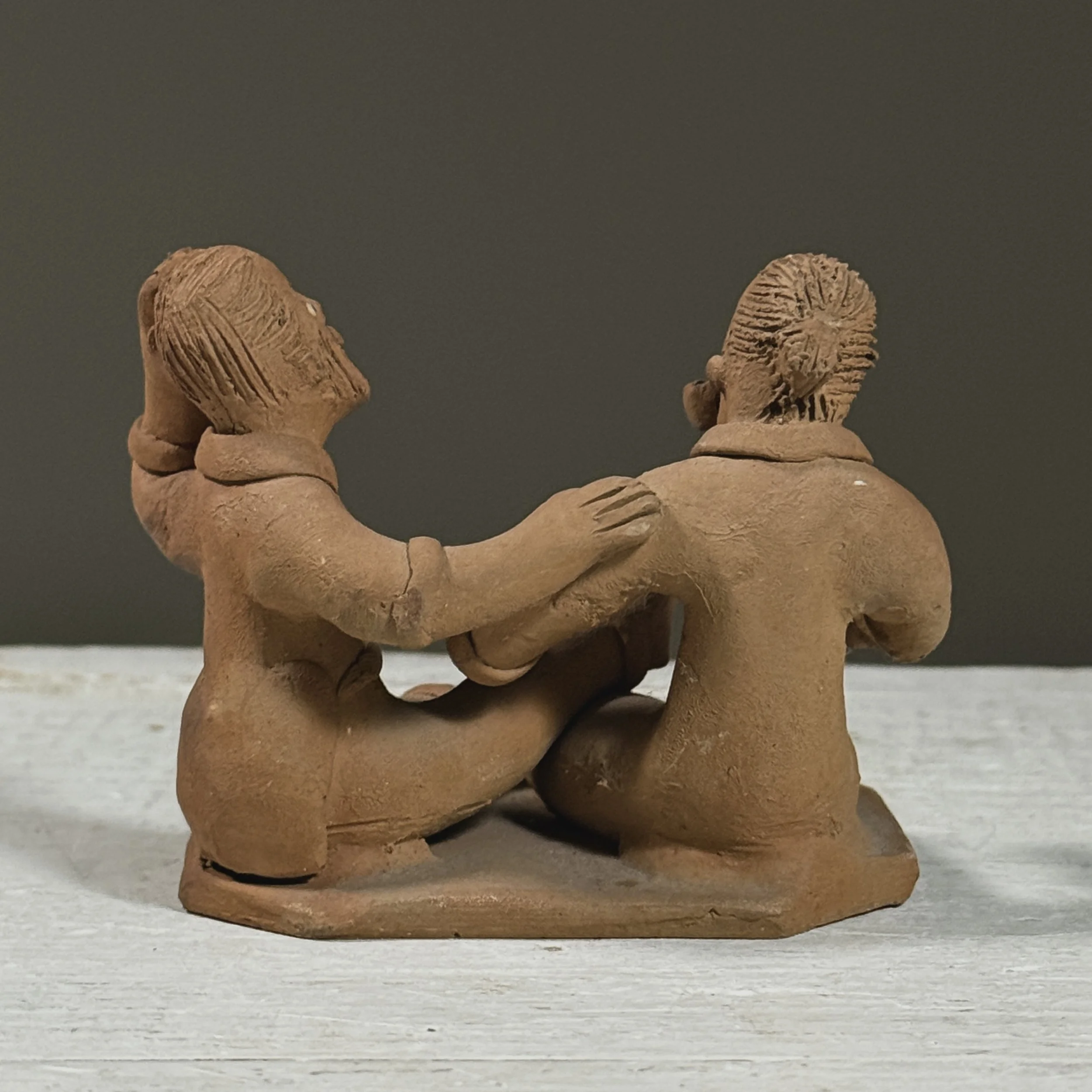 Vintage Brazilian folk art clay sculpture of two figures, signed Berenice