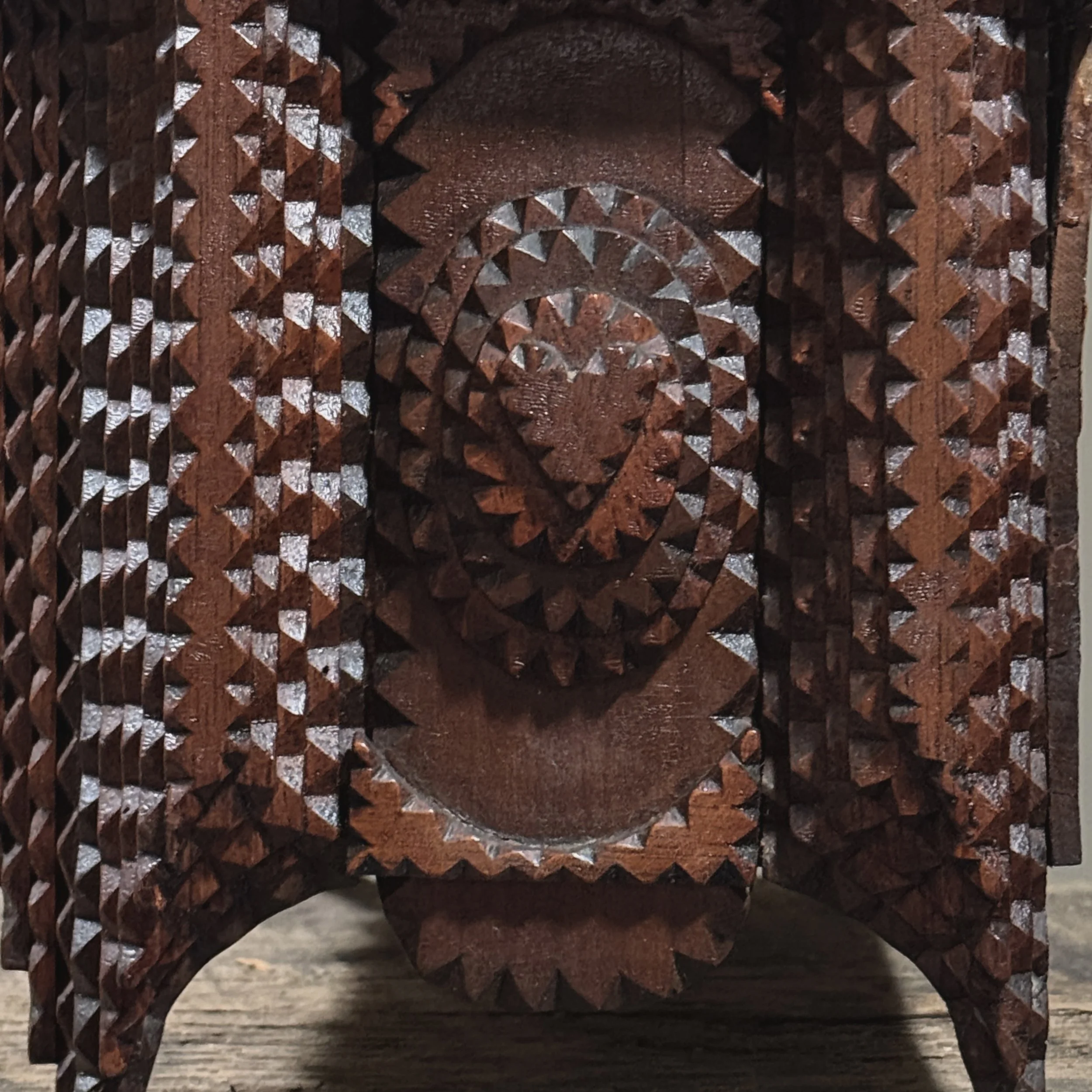 Carved heart detail on the side panel of tramp art dresser