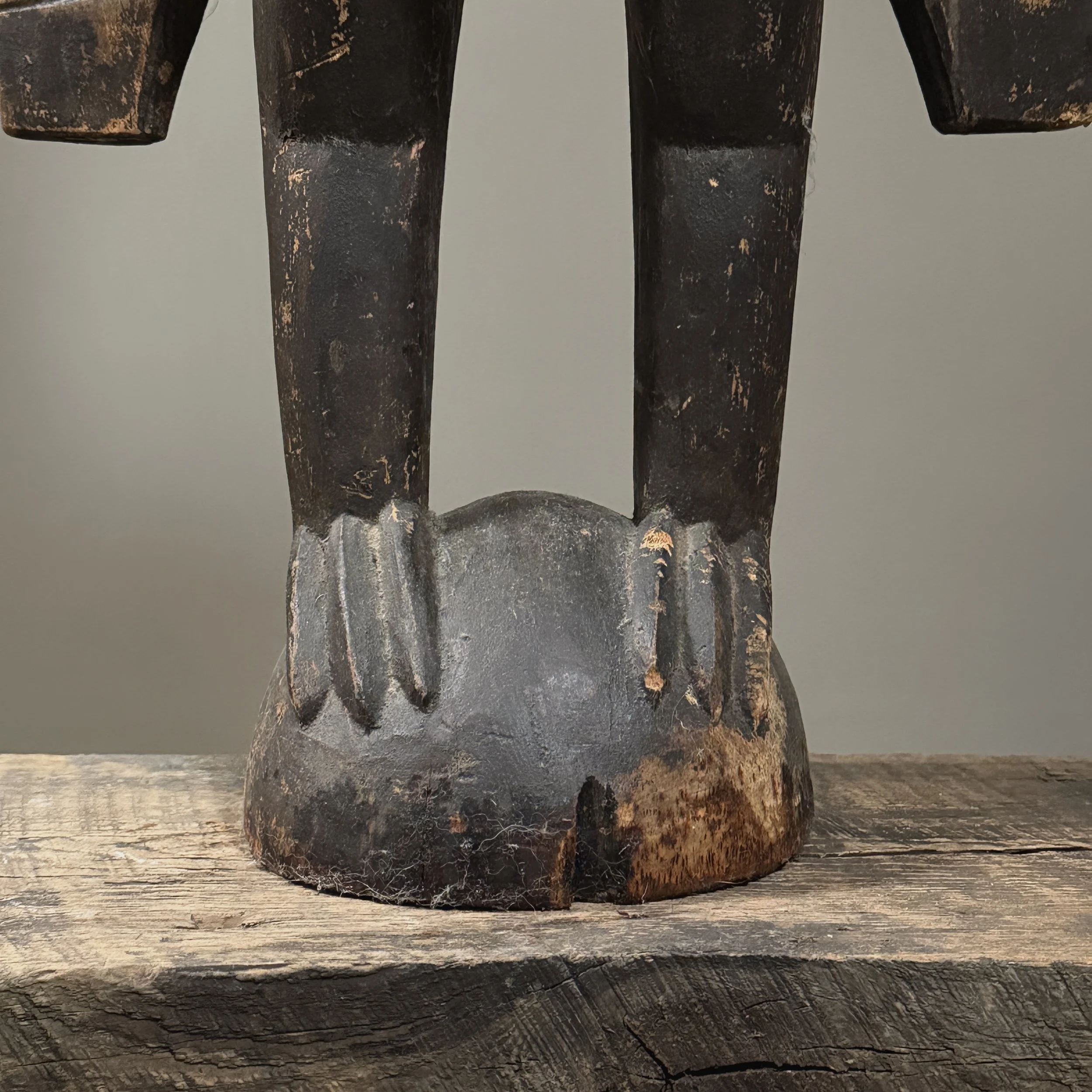 Base detail showing carved spherical perch