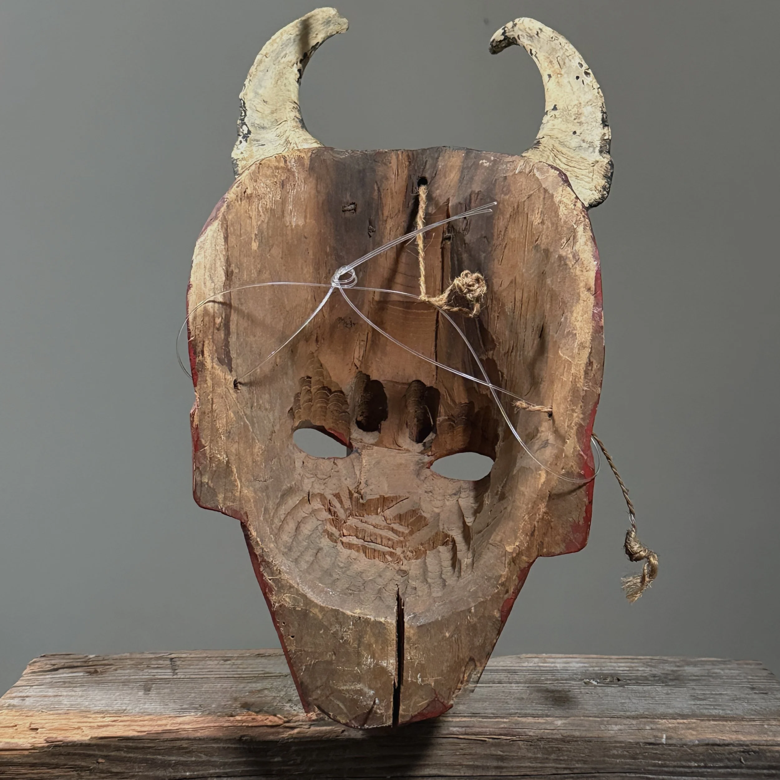 View of the mask's interior, showing wear and carving marks.