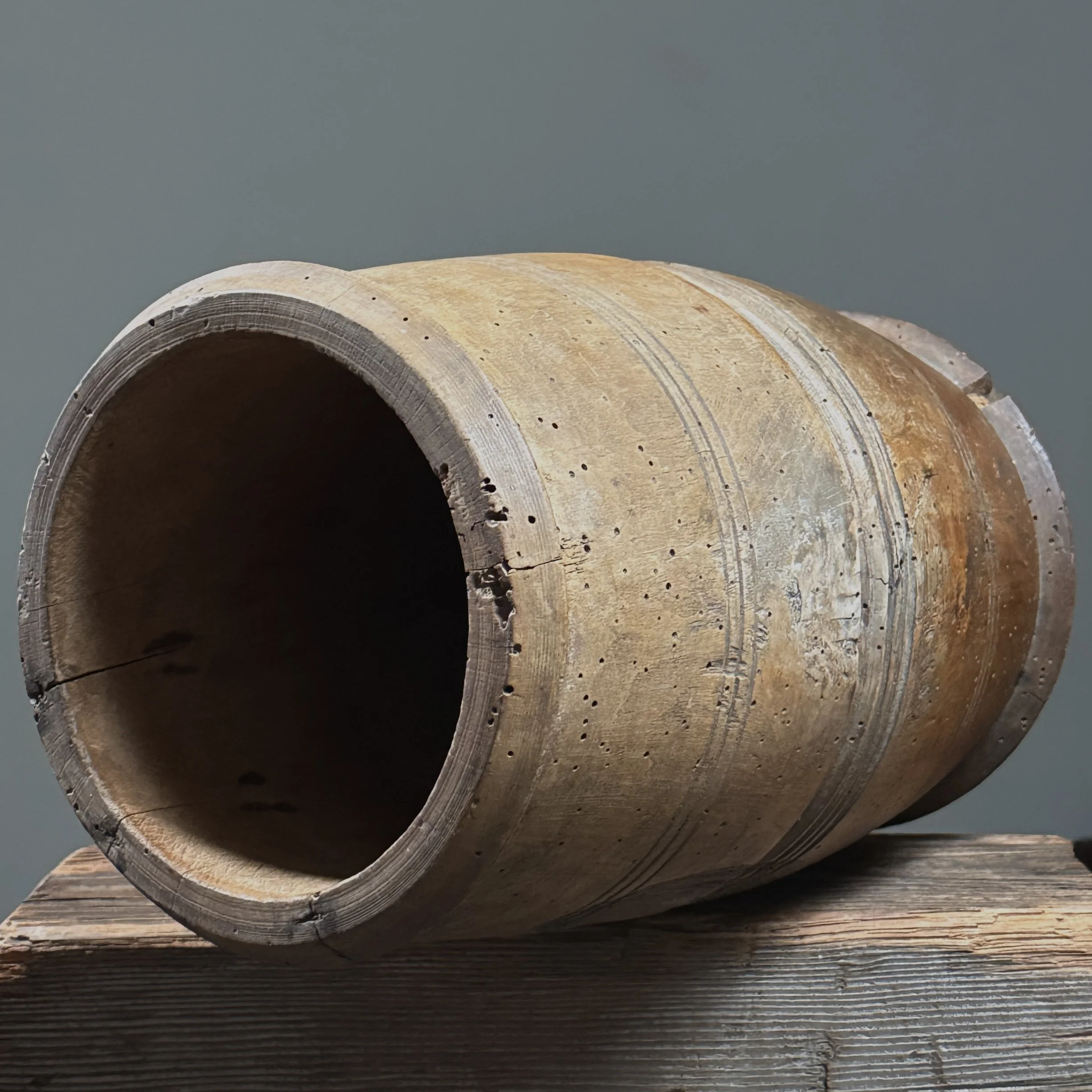 Front view of antique treenware barrel with concentric ribbed bands