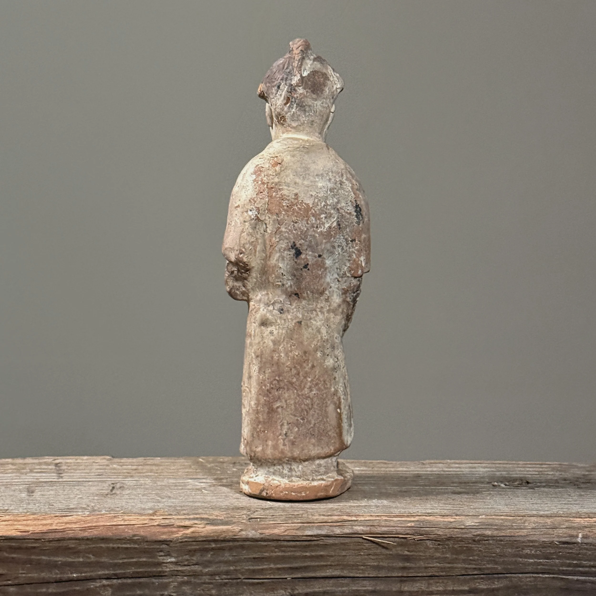 Rear angle displaying the flat back and unadorned surface of the molded earthenware.