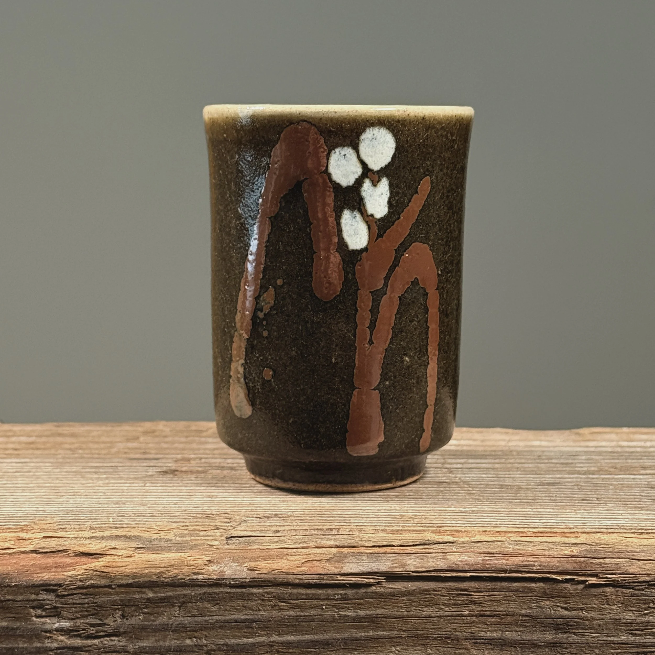 Front view of brown cup.