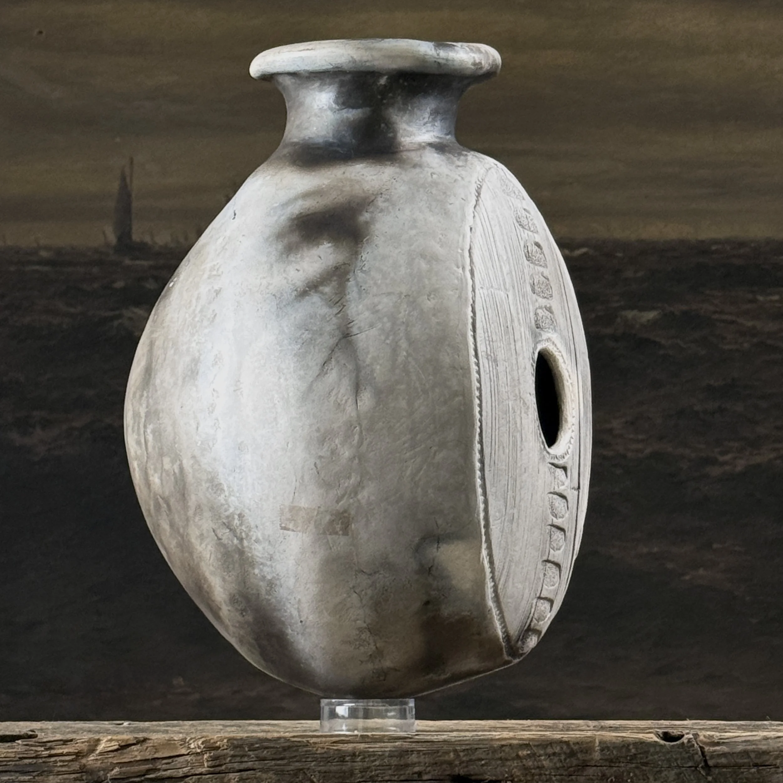 Vintage raku fired vessel with hole in center, signed with maker's mark