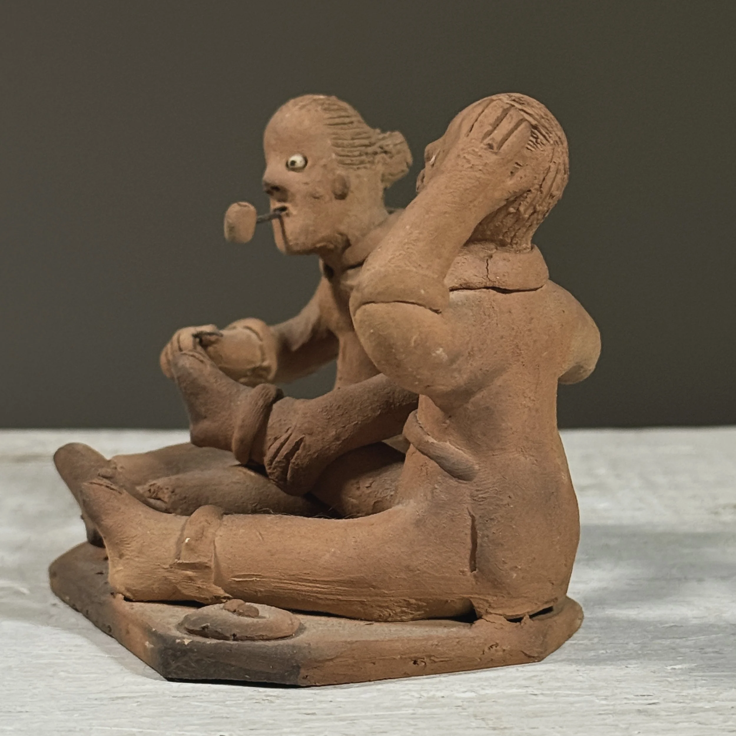 Vintage Brazilian folk art clay sculpture of two figures, signed Berenice