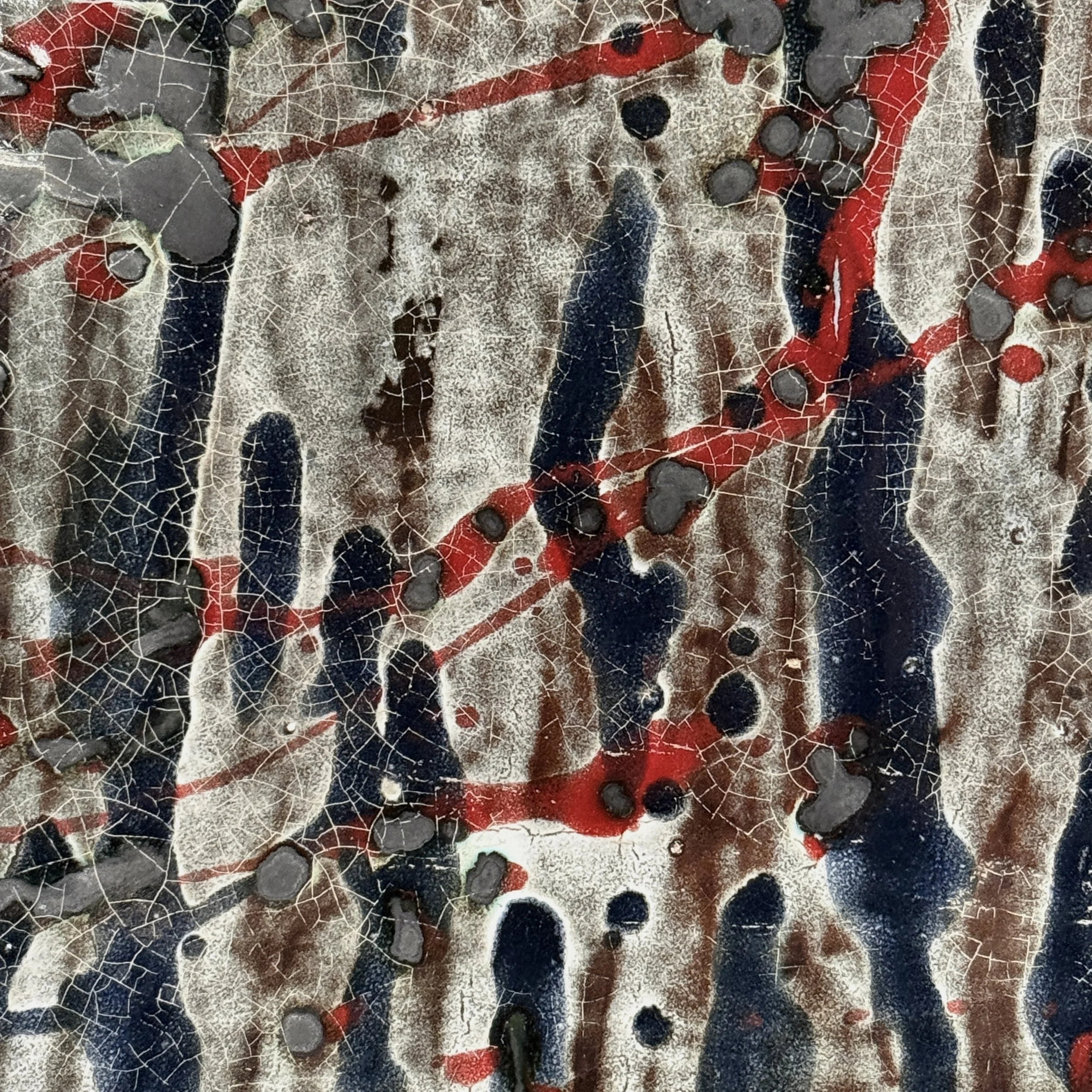 Detail of splatter glaze. Abstract Expressionist gesture. Blue and red pigment application.