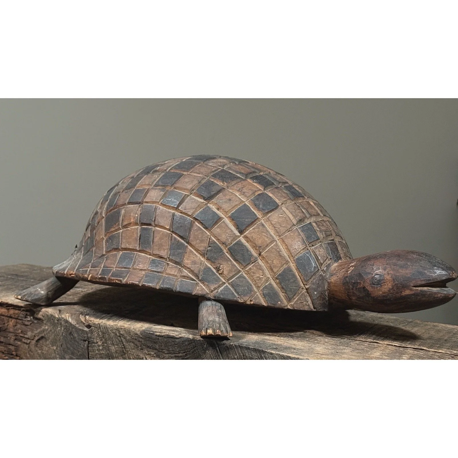Folk art turtle carving with geometric shell design