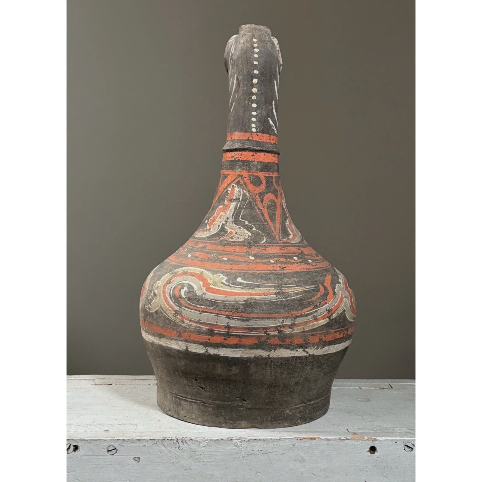 Zoomorphic Chinese vessel with spout shaped as guardian animal, back view.