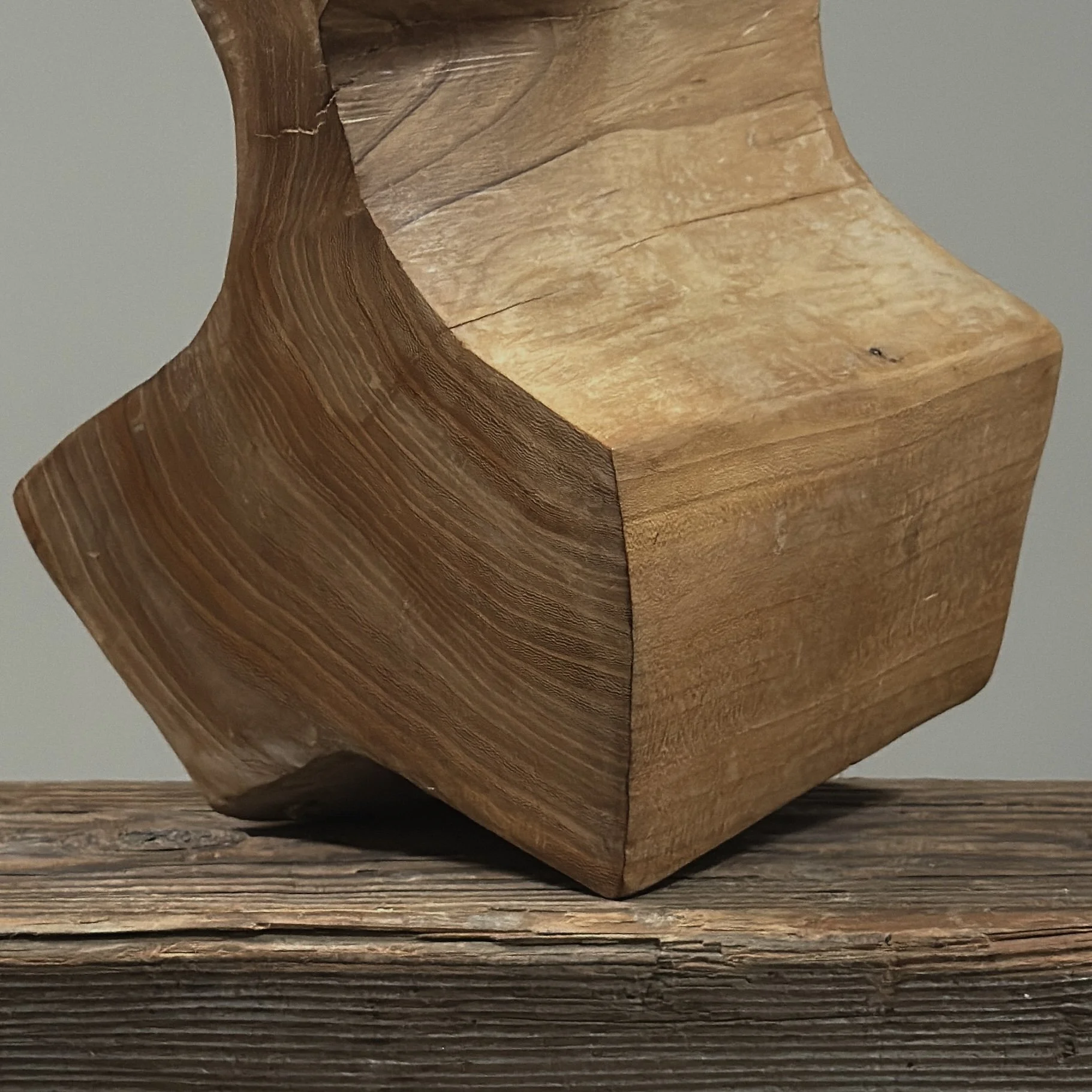 Close-up detail of carved geometric facets on vintage Danish cubist portrait sculpture, hand carved wood