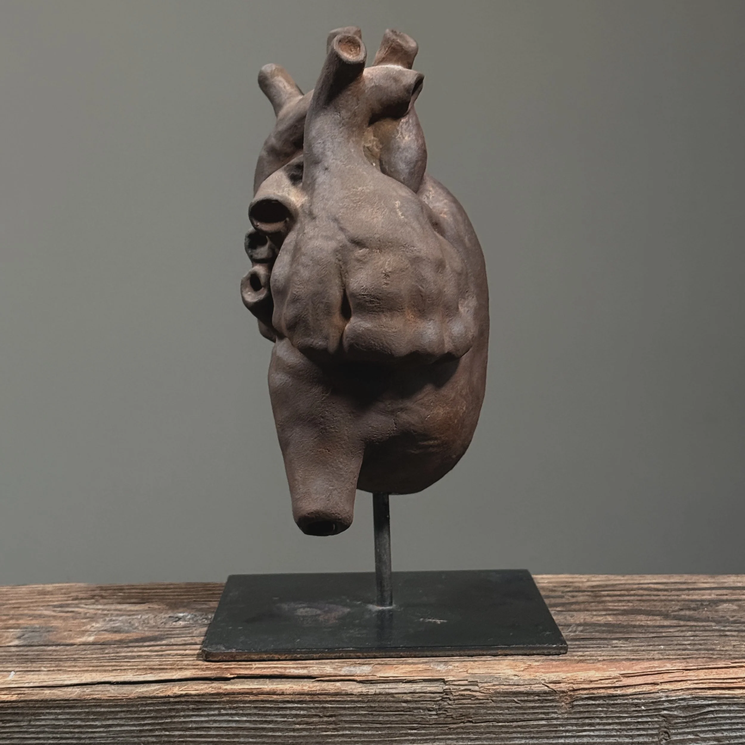 Side view of hand-built clay heart artwork