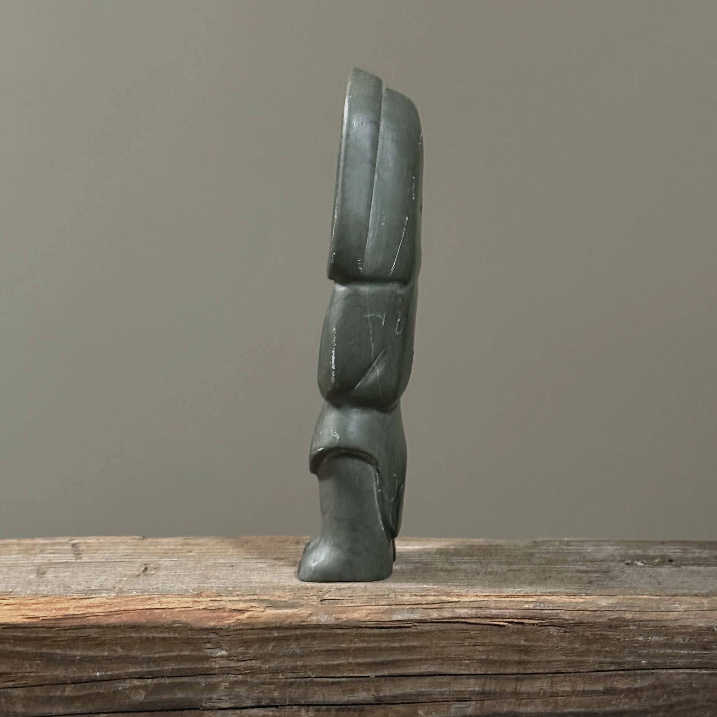 Side profile of Inuit sculpture by Annie Niviaxie