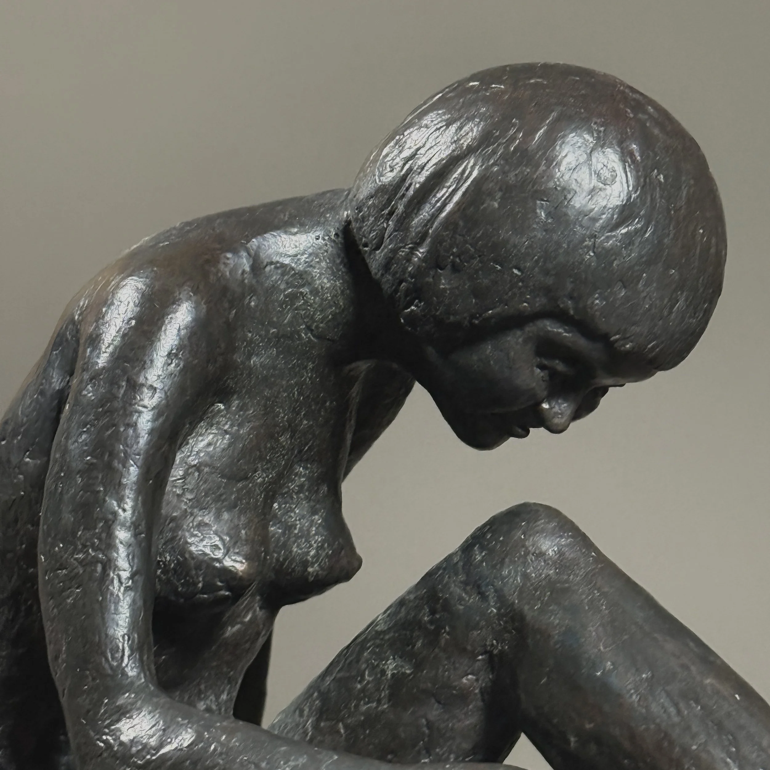 Side profile of sculpture. Expressive bronze modeling visible. 8.5 inches depth.