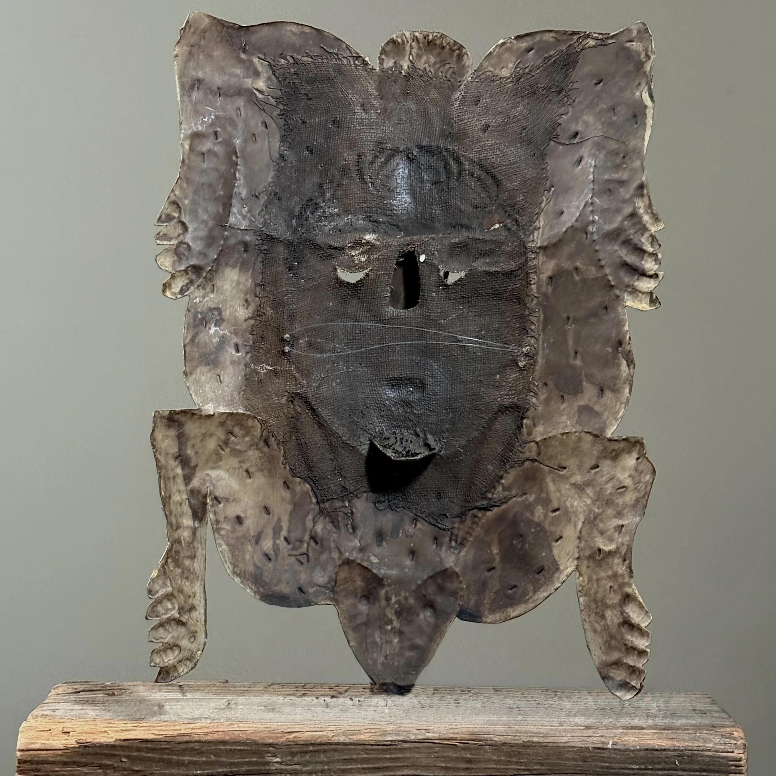 Antique Guerrero folk art rabbit woman mask in polychrome copper Back view.