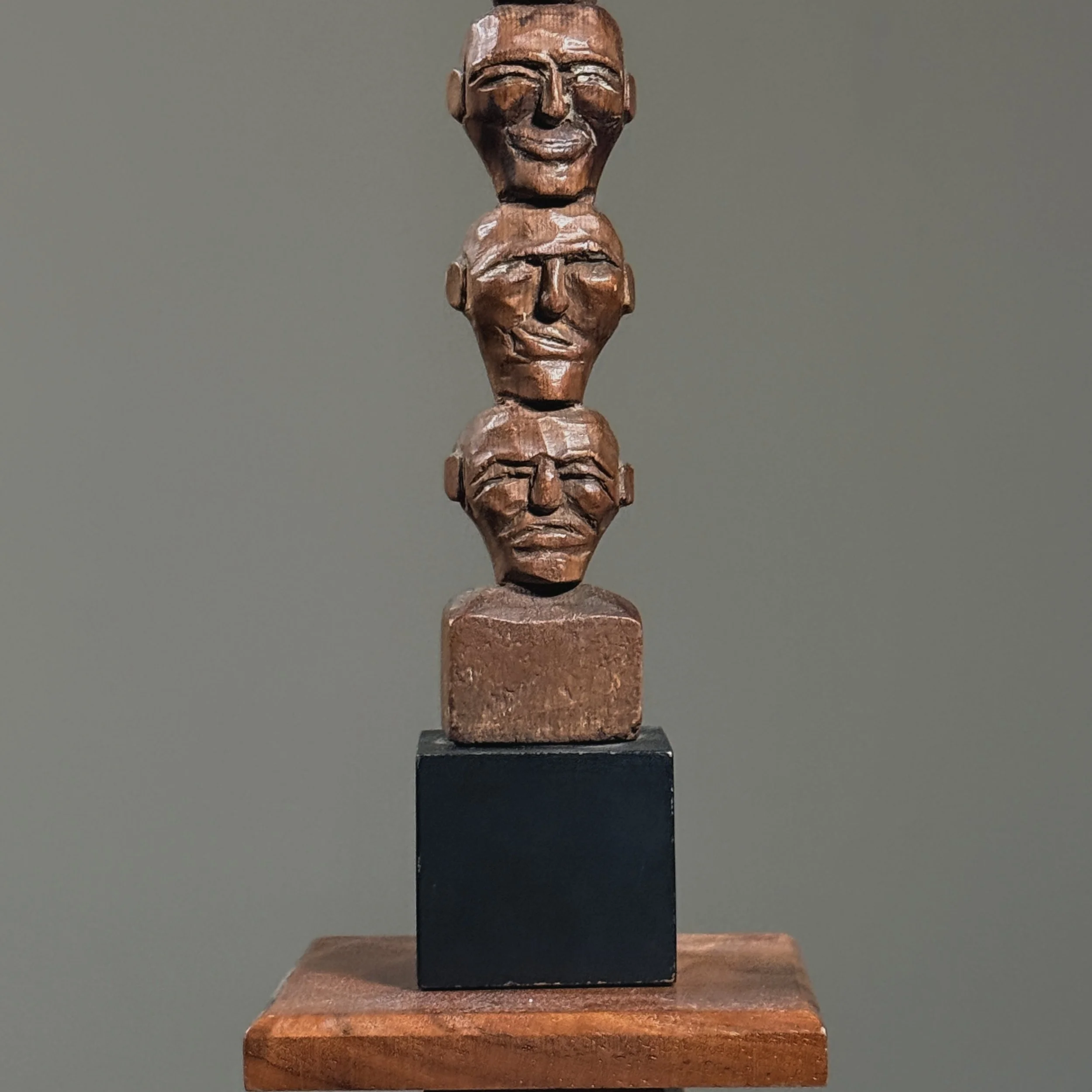 Detail view of hand-carved wooden faces