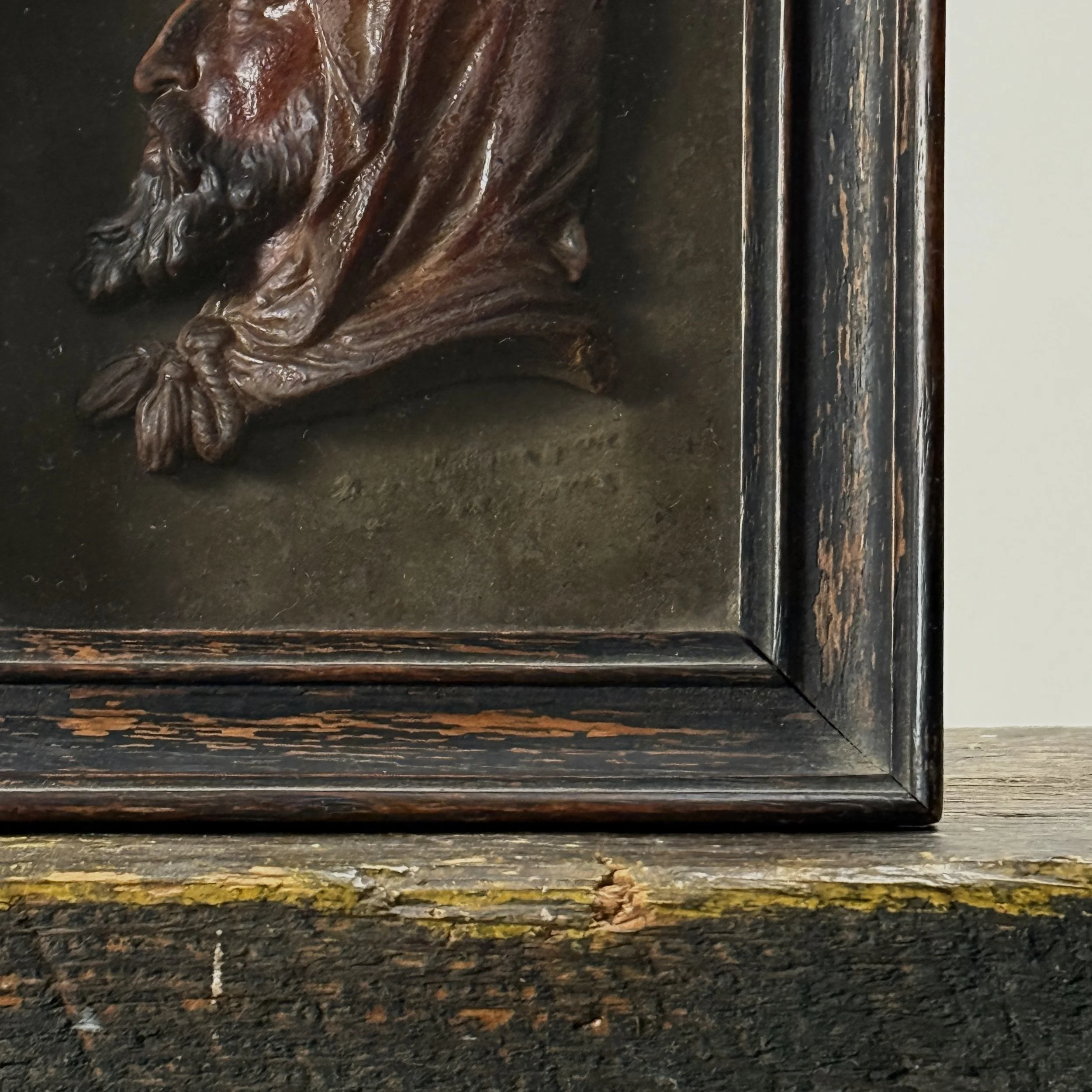 Close-up of signature on back board of antique French wax profile, signed lower right, dated 1761 Paris