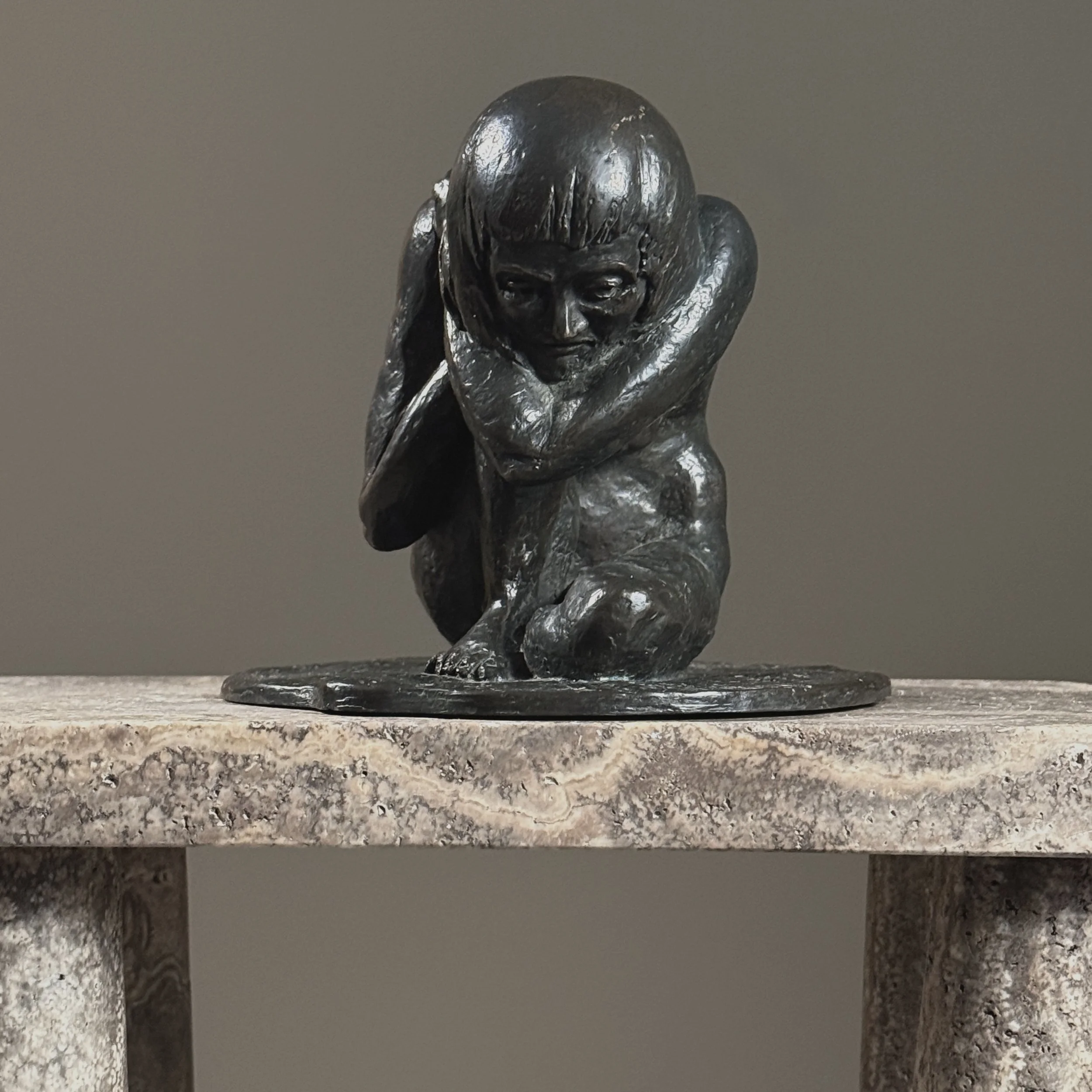 Full frontal view of a vintage realist bronze sculpture of a crouching nude woman by Alma Helbig Hobson