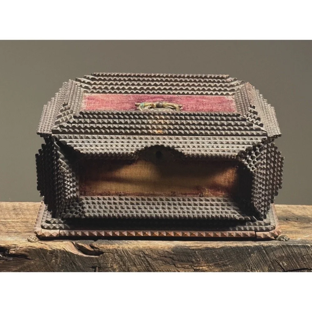 Front view of an antique tramp art box with purple velvet panels.