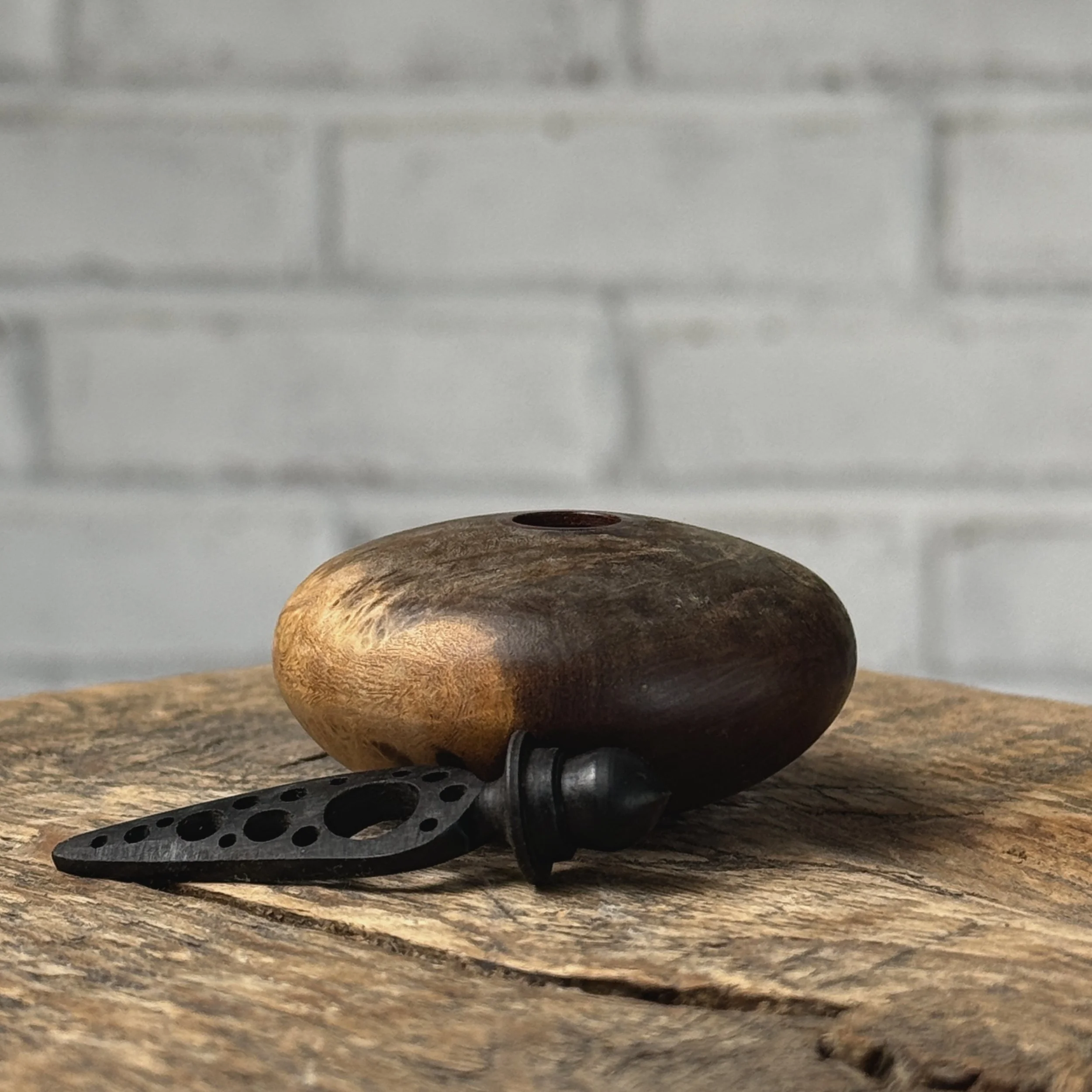 Handcrafted ebony topper removed from miniature burl wood container
