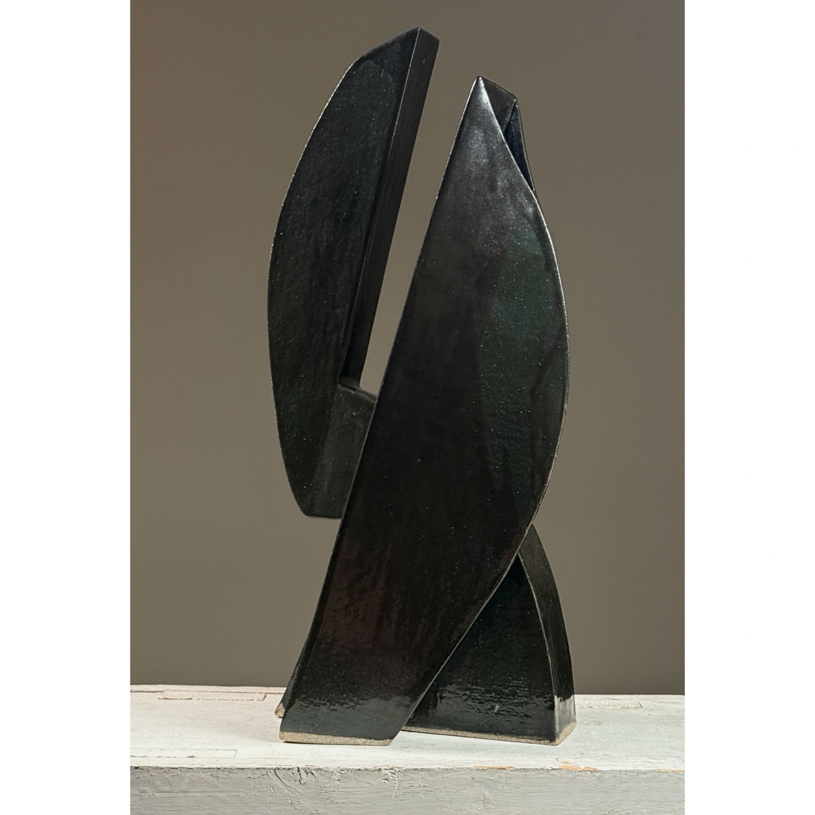 Postmodernist sculptural ceramic ikebana vessel. Glossy black and subtle green glaze. 18.25 inches height.