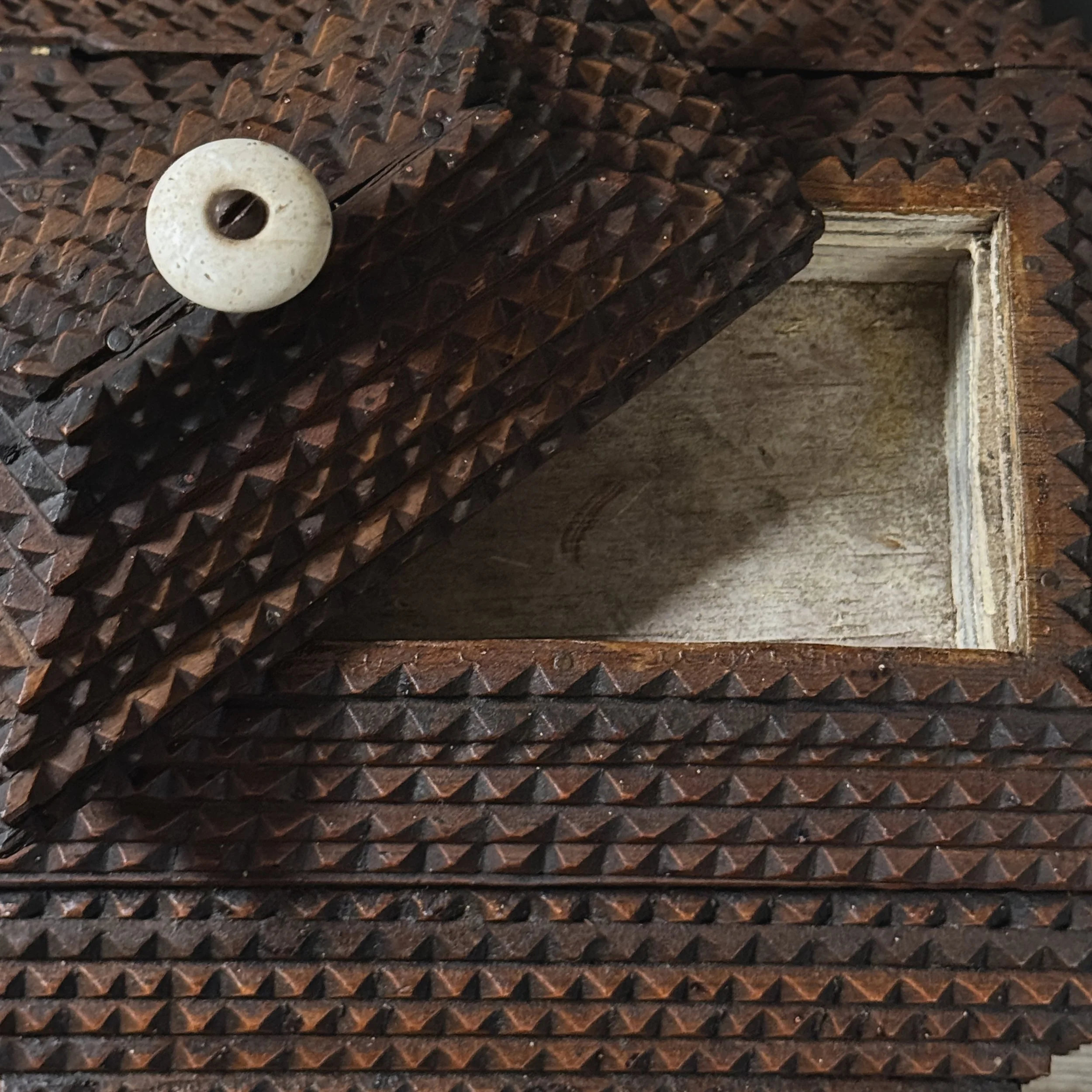 Overhead view of tramp art pyramid lid with finial and compartments