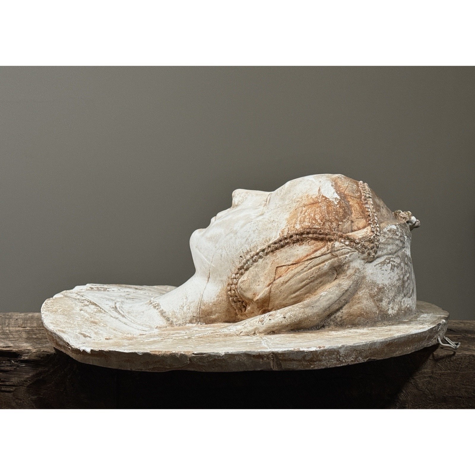 Profile view of the sculptural relief.