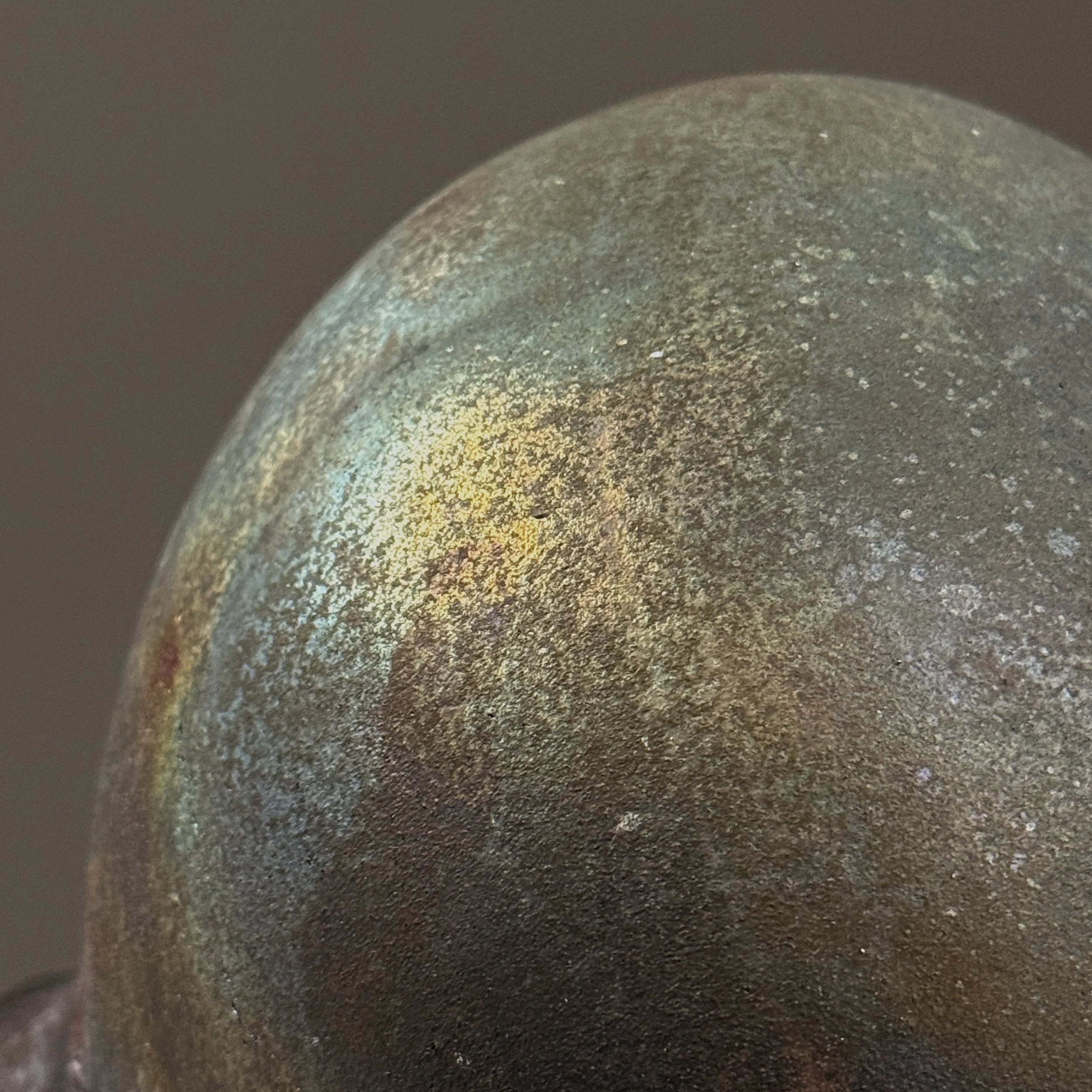 Surface detail. Iridescent variations across exterior.