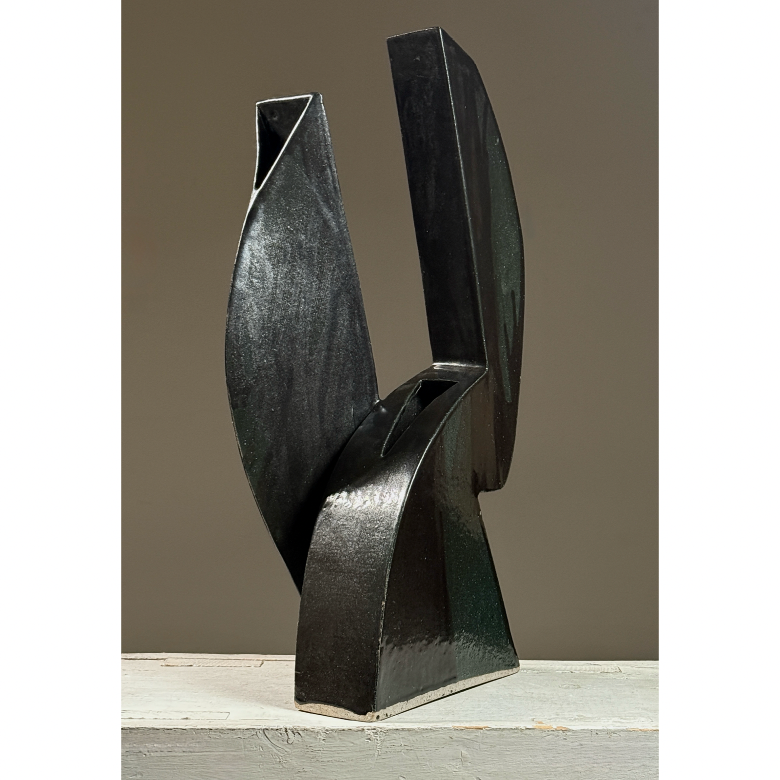 Postmodernist sculptural ceramic ikebana vessel. Glossy black and subtle green glaze. 18.25 inches height.