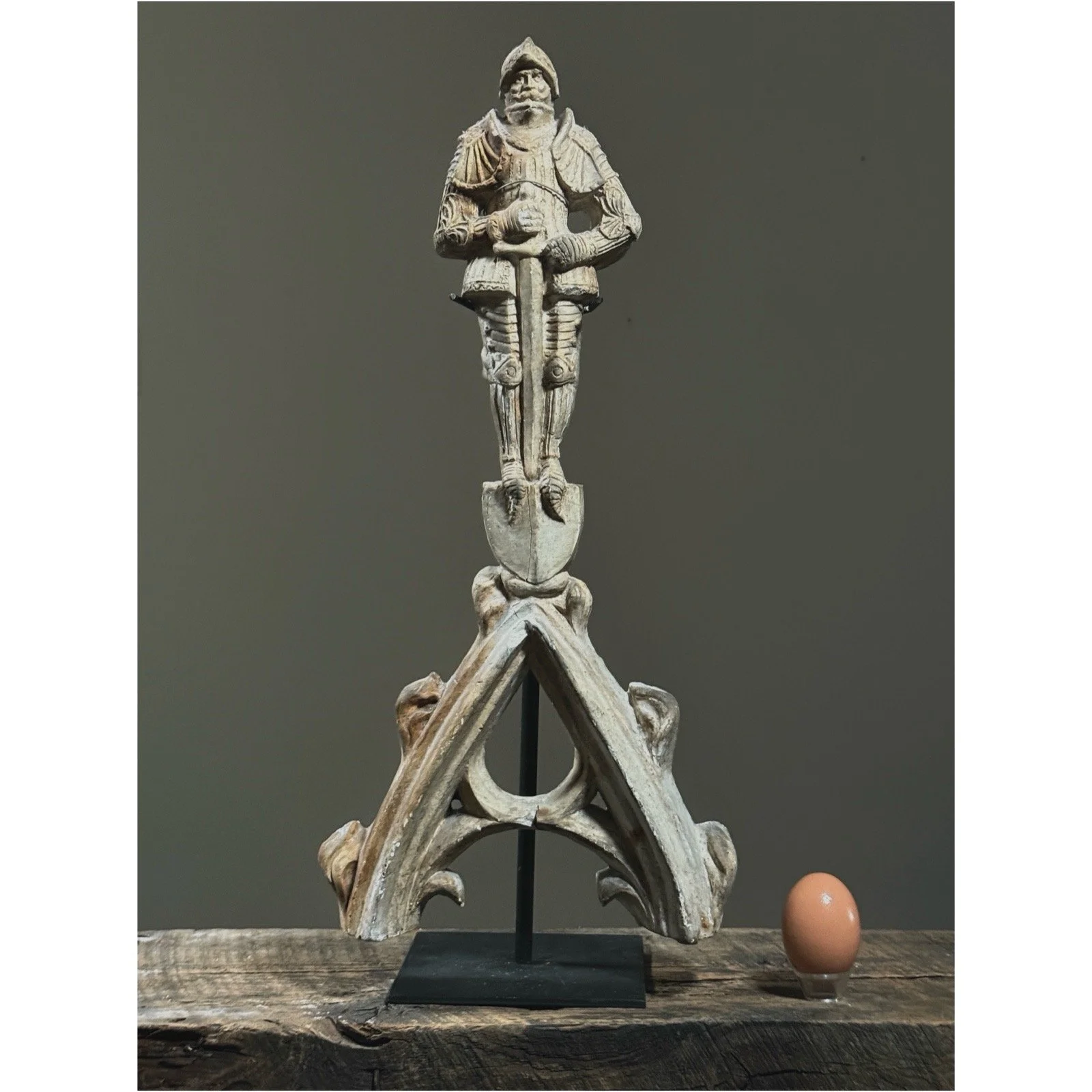 Antique plaster arch architectural remnant from Northern Europe with an egg for size reference.